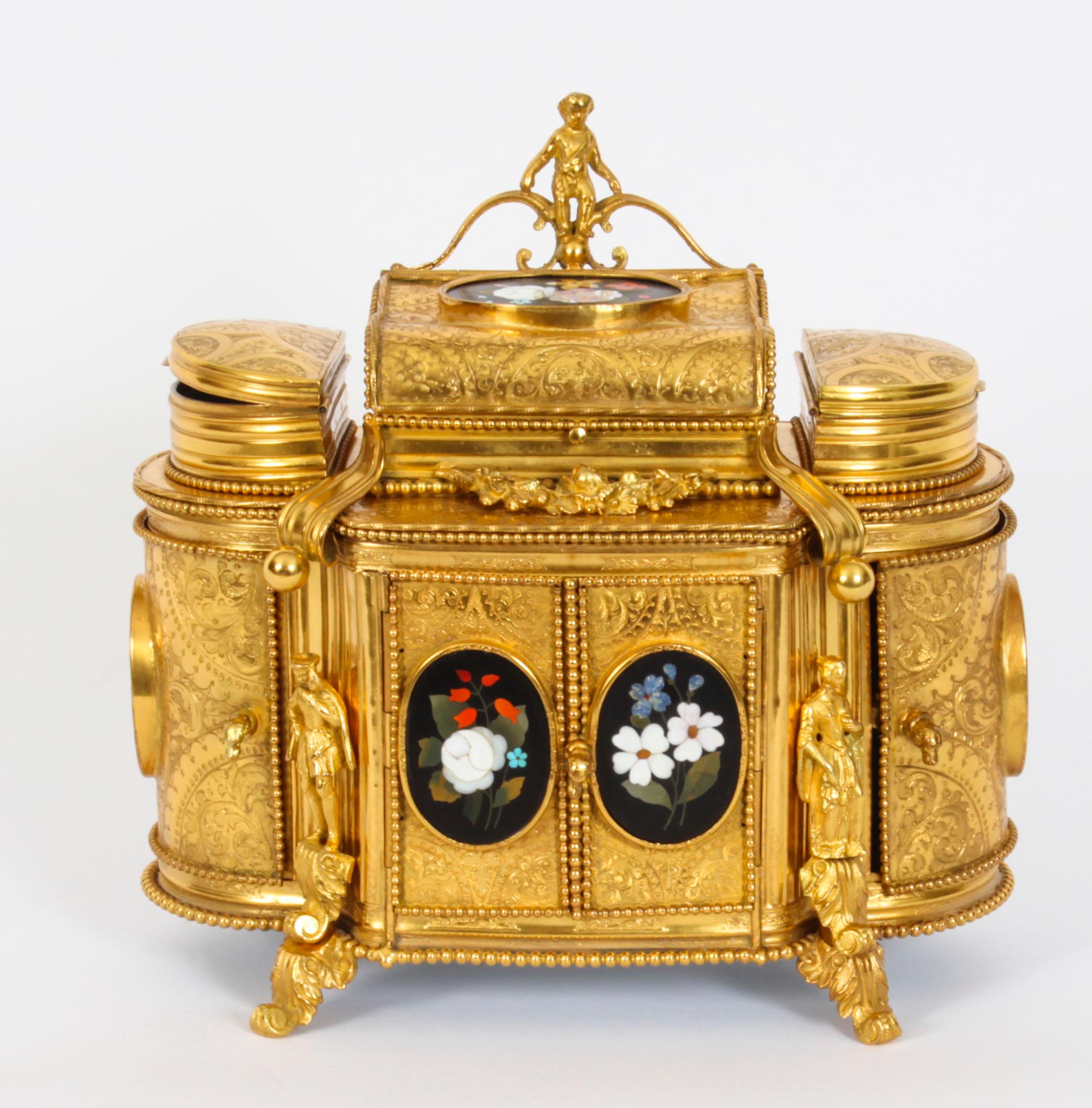 This is an absolutely fabulous antique French engraved ormolu and Pietra Dura mounted jewellery cabinet, Circa 1860 in date.

The casket is in the form of a cabinet, with three fitted jewellery compartments on the top,  the central compartment  is