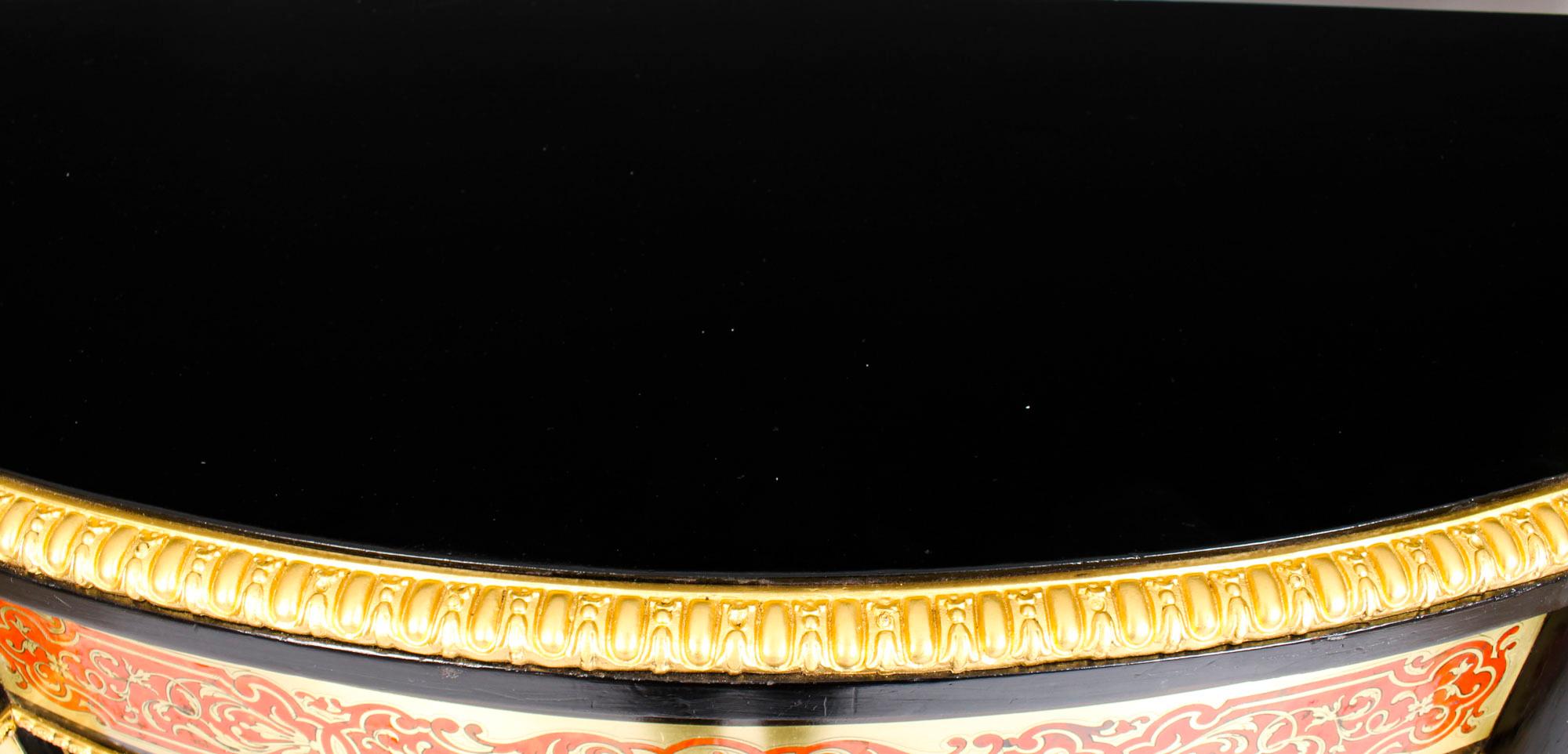 This is an important antique, Victorian, ebonised, ormolu mounted, and red Boulle cut brass marquetry serpentine credenza, circa 1870 in date.

It is beautifully inlaid in cut brass, in addition there is scrolling acanthus foliage with flowers and