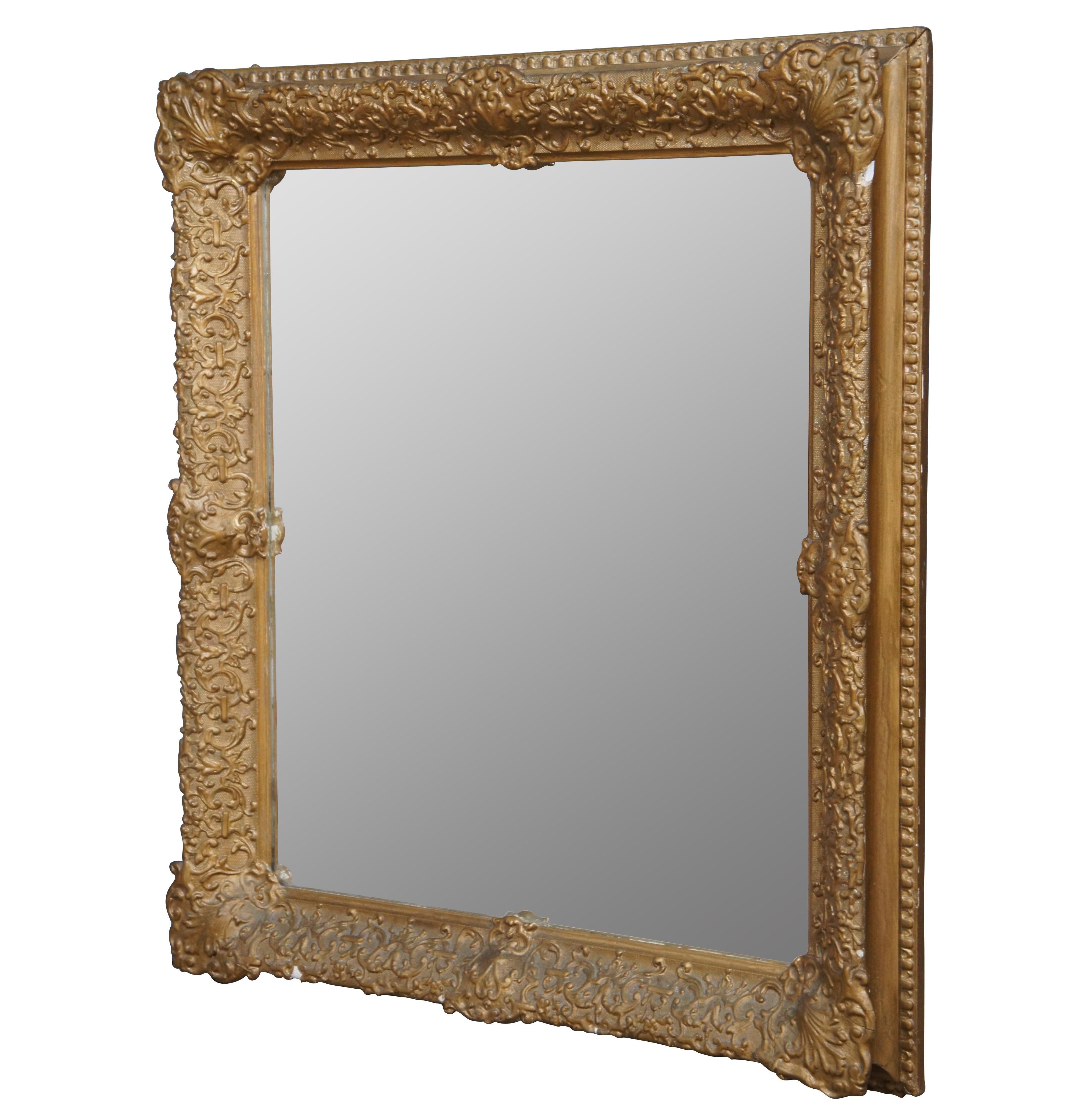 Antique rectangular wall mirror featuring gilded plaster / gesso over wood frame, molded with swirling foliate and scallop motifs.

Measures: 27.5” x 3” x 30.5” / Sans Frame - 20.75” x 24” (Width x Depth x Height).