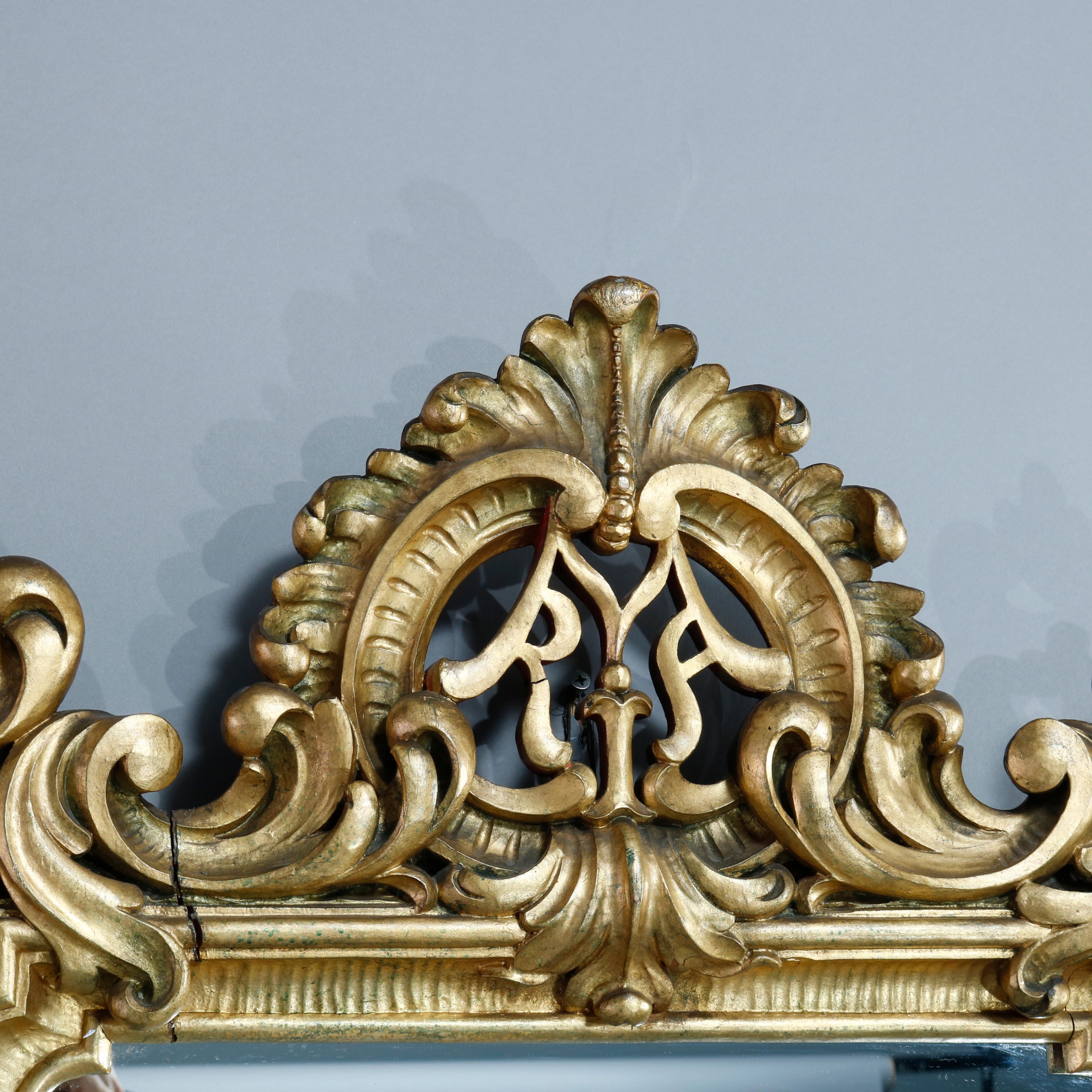 An antique French Louis XIV style wall mirror offer giltwood frame with pierced foliate crest and scroll acanthus elements throughout, c1900.

Measures: 42.5