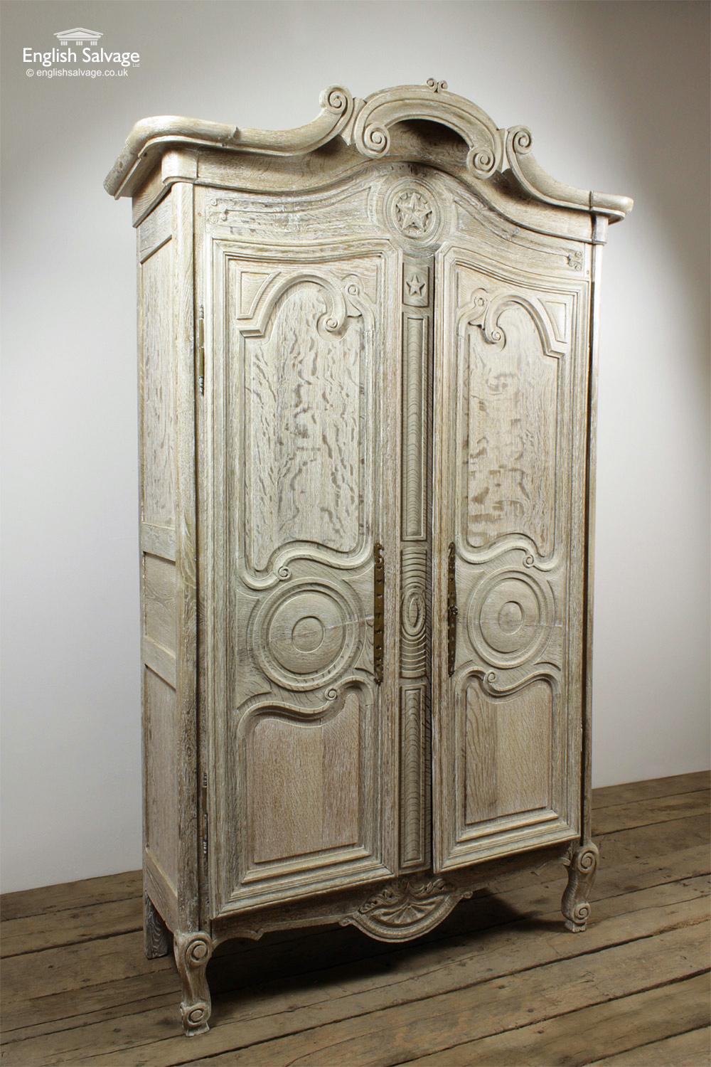 Antique, ornate oak armoire, wardrobe, cupboard decorated with scrolls and stars, complete with attractive thin brass fingerplates. Width at top of unit 147.5cm, main body width 130.2cm.

Few splits, signs of old worm to the rear, one internal