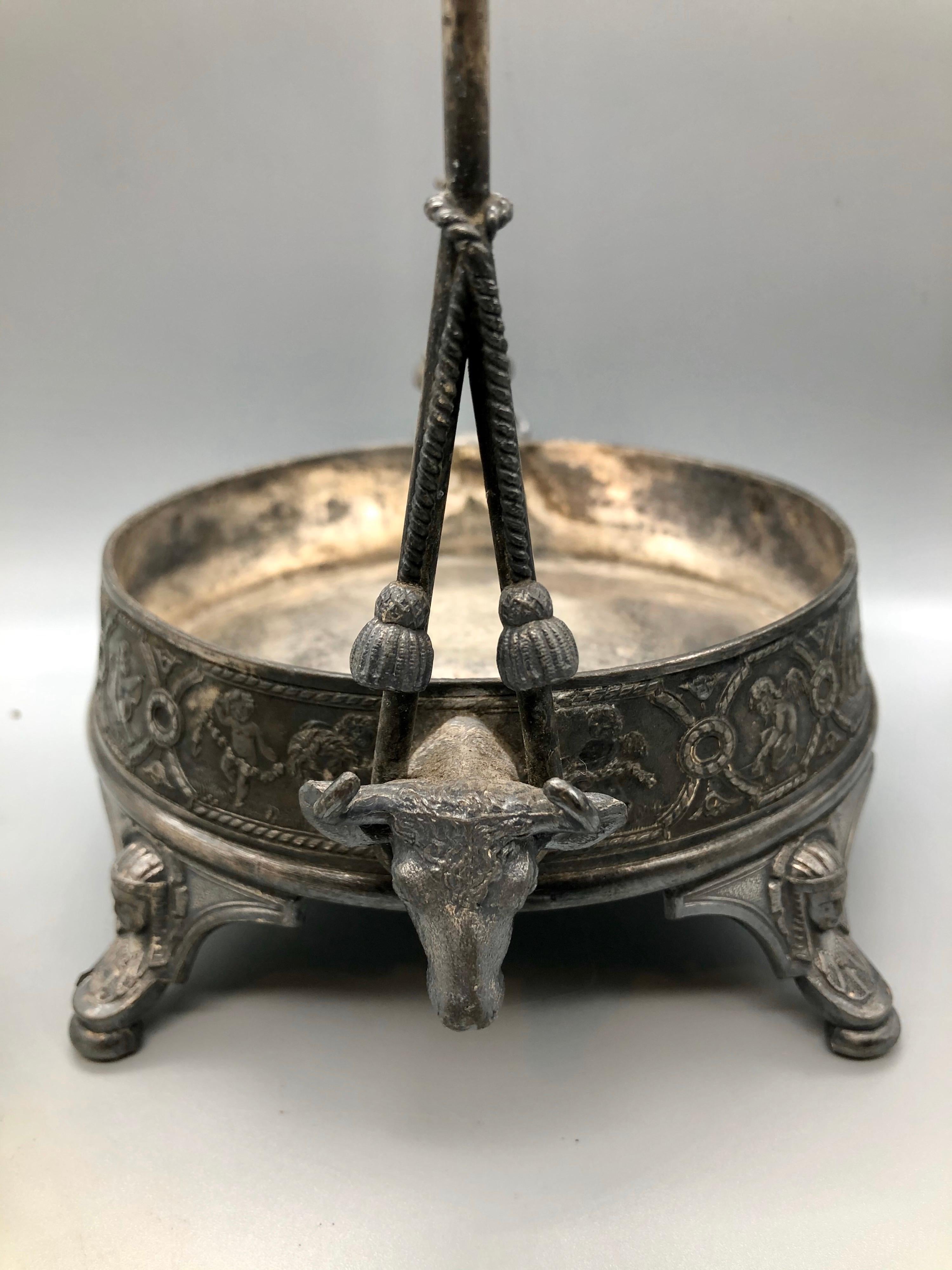 This antique cut-glass silver plated pickle caster dates from the late 1800s Victorian era. Note the exceptionally detailed design of angels at rest and play. Shows some age, but the detailing really sets this apart from other castors of the