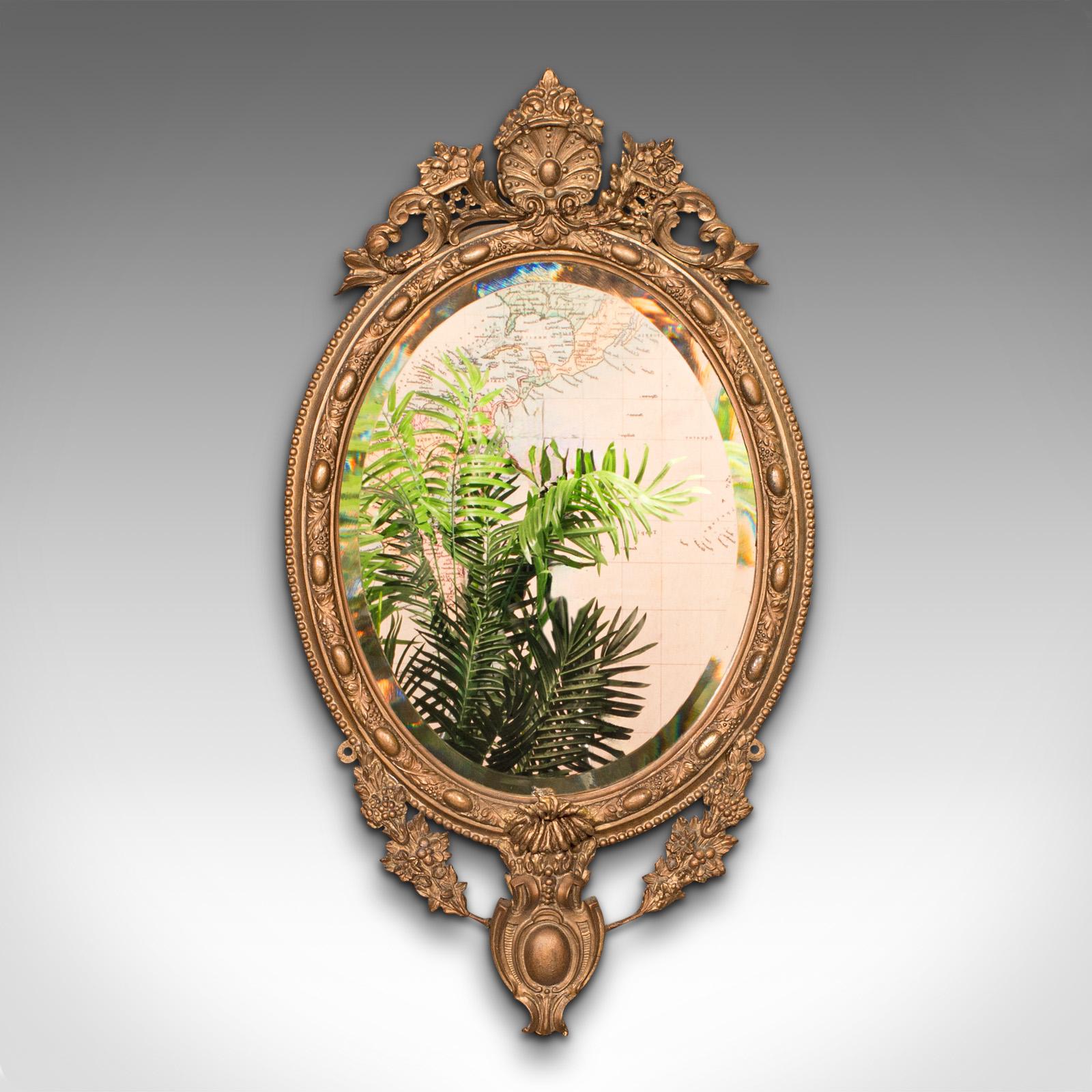 This is an antique ornate wall mirror. A French, gilt gesso and bevelled glass mirror, dating to the late Victorian period, circa 1900.

Dashing wall mirror with an ornate continental elegance
Displays a desirable aged patina and in good original