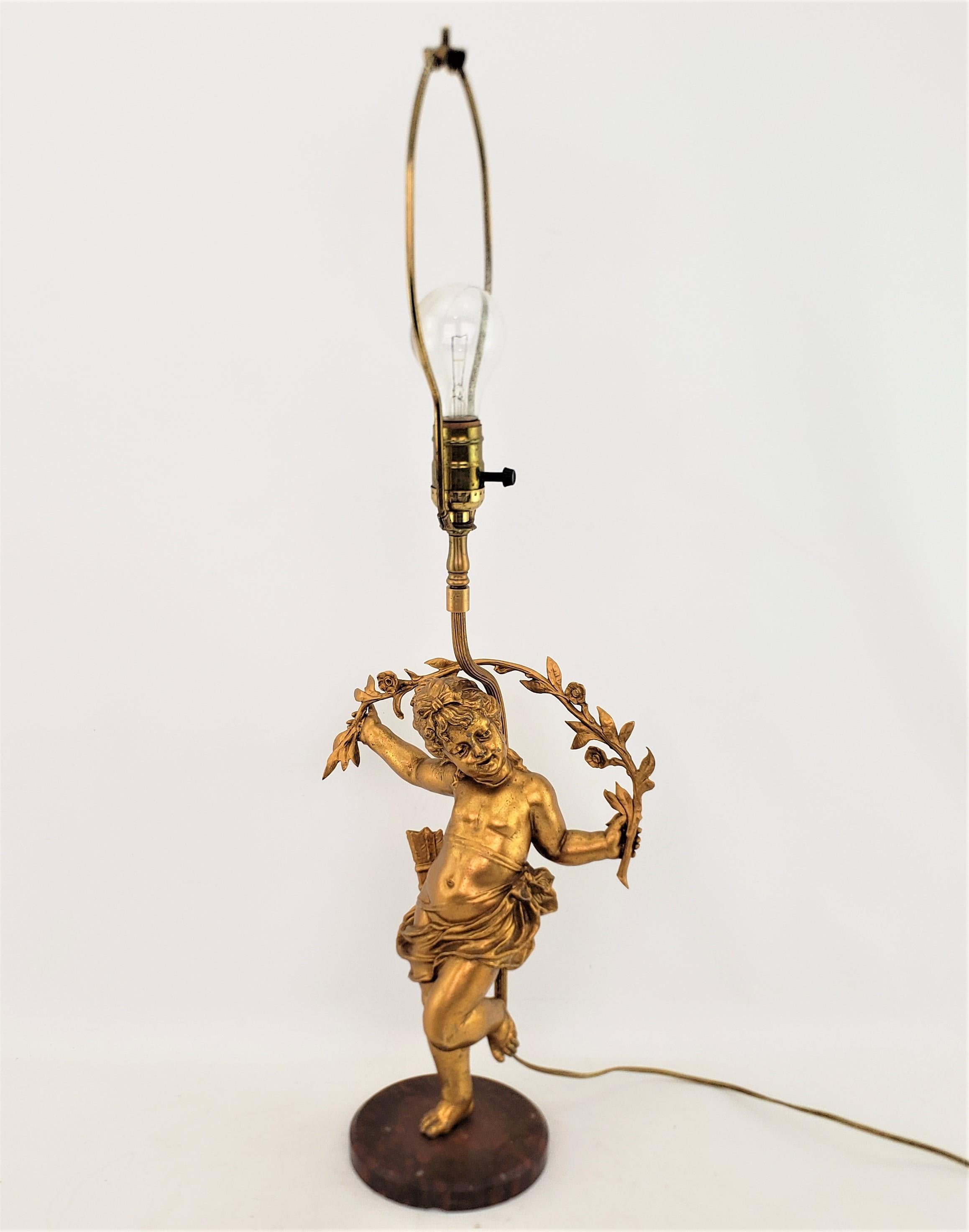 Hollywood Regency Antique Ornately Cast & Gilt Finished Sculptural Cherub Table Lamp For Sale