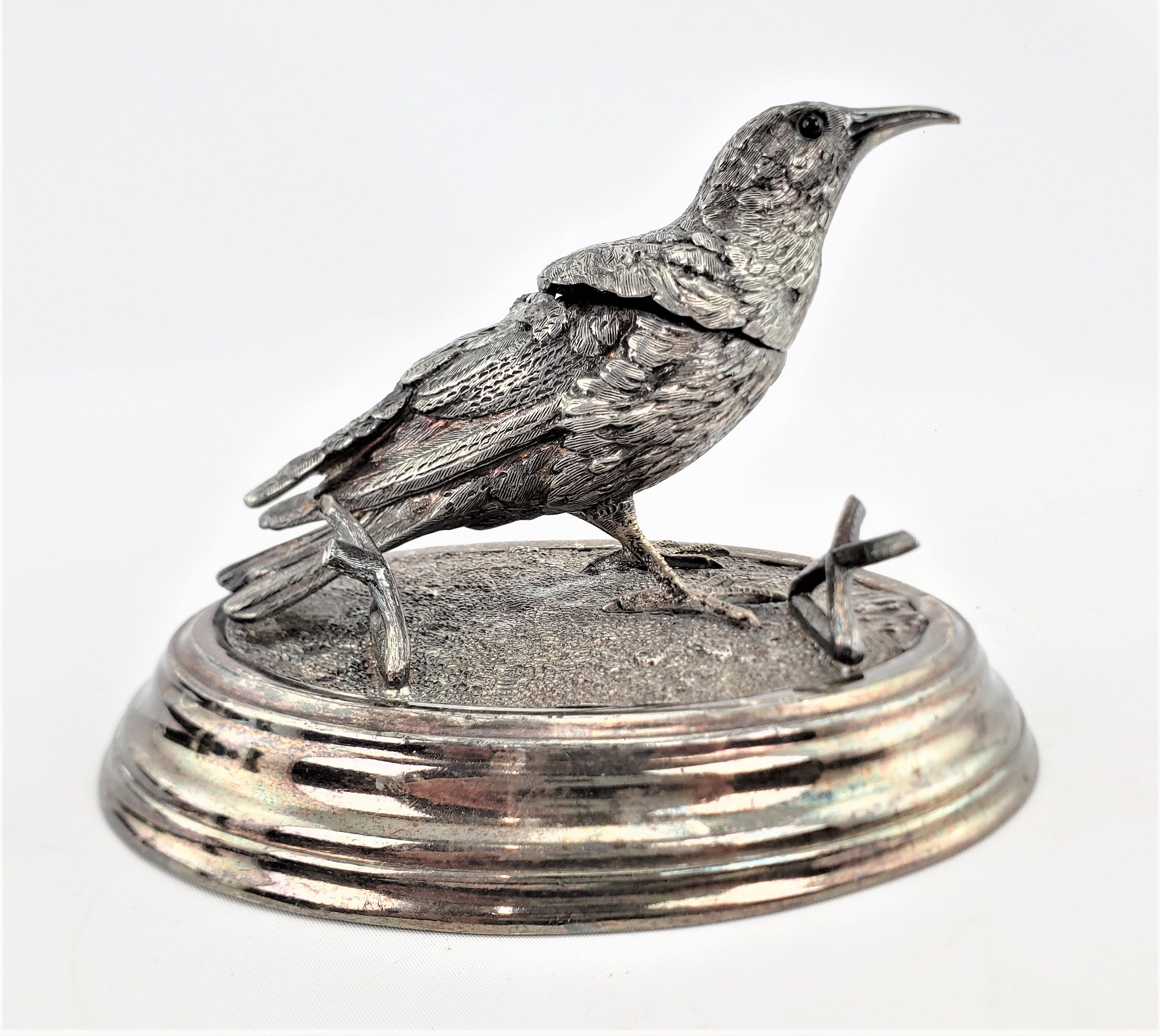 This antique silver plated figural inkwell was made by the renowned James Deakin & Sons of England in approximately 1880 in the period Victorian style. The inkwell or sculpture depicts a standing bird, presumably a raven, with some crossed broken