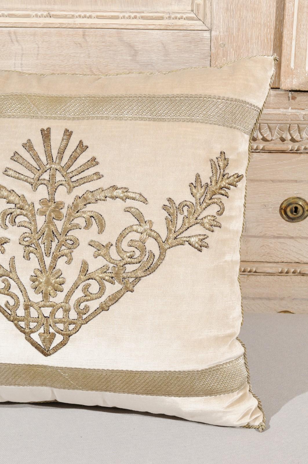 An antique Ottoman Empire raised silver metallic embroidery on oyster velvet fabric, made into a down-filled pillow. We currently have two pillows available, priced and sold individually. Made of an exquisite antique Ottoman Empire raised silver