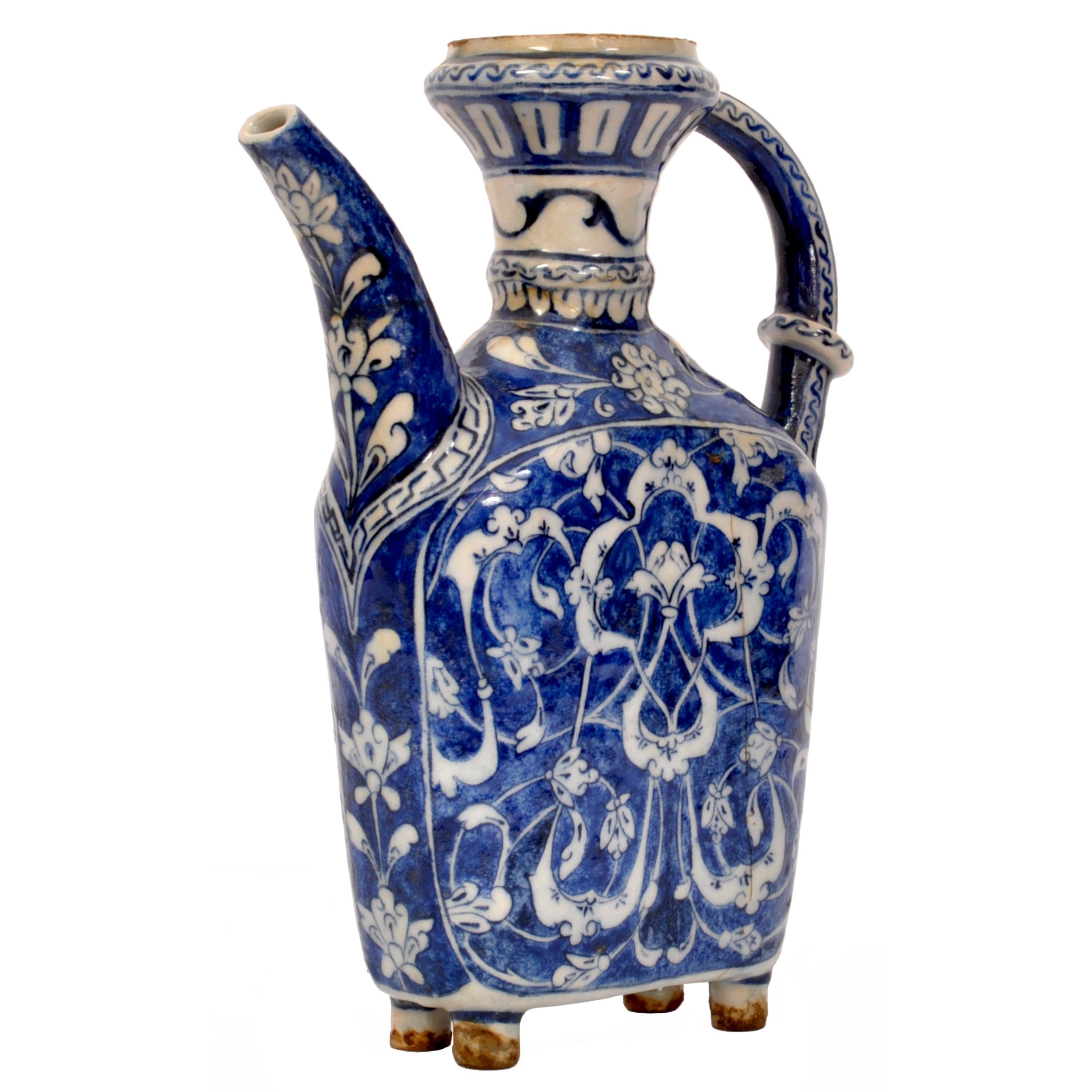 A good antique blue and white Iznik pottery spouted water jug, circa 1650.
An unusual Iznik ewer of compressed form, having a flared neck, connected to the compressed body of the ewer with an arched handle. The jug having a gently arched pouring