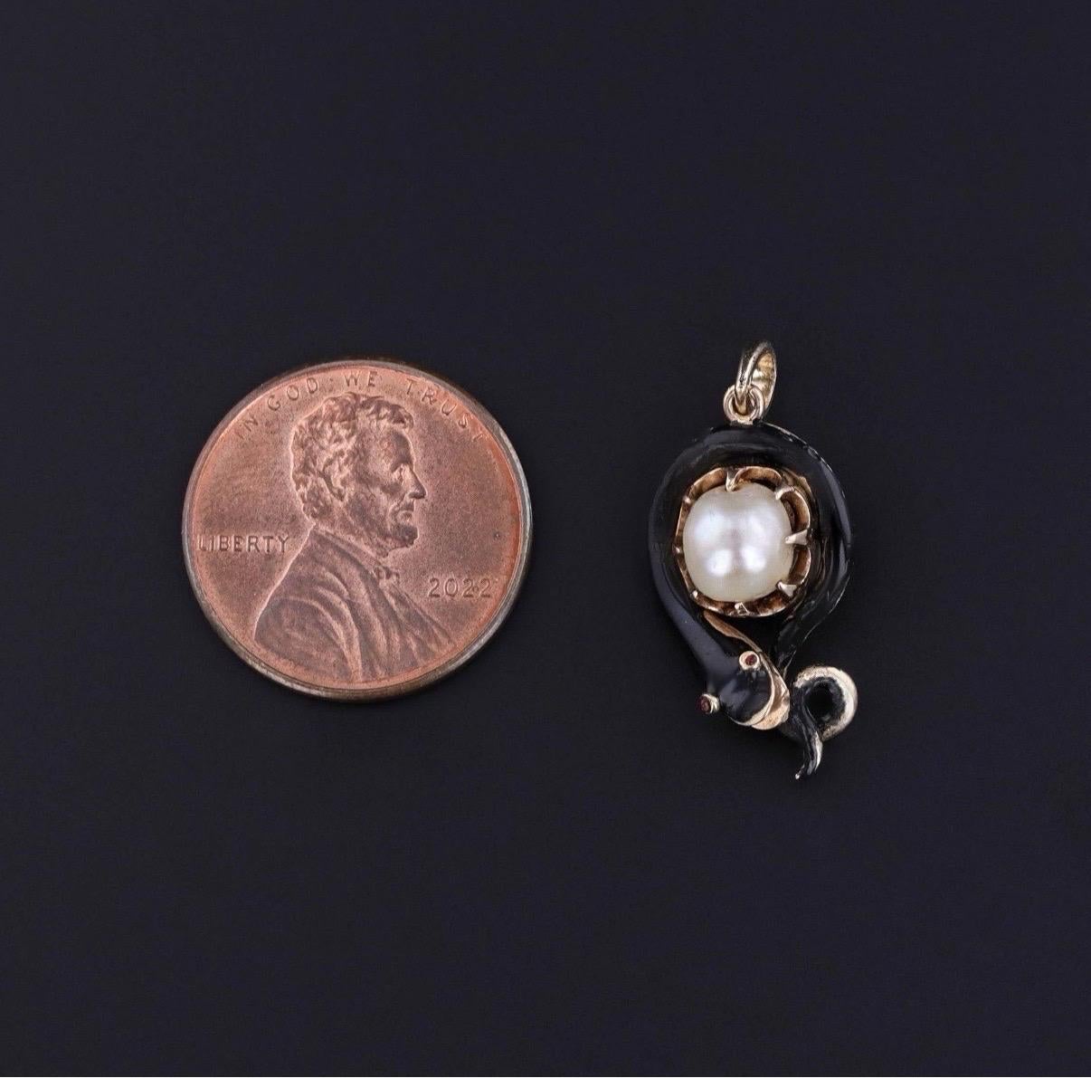 Symbolic and steeped in sentiment, this antique mourning pendant (dated 1848) features a beautiful snake coiled protectively around a luminous pearl, crafted in warm 12k gold and rich black enamel. The snake—a powerful symbol of eternity,