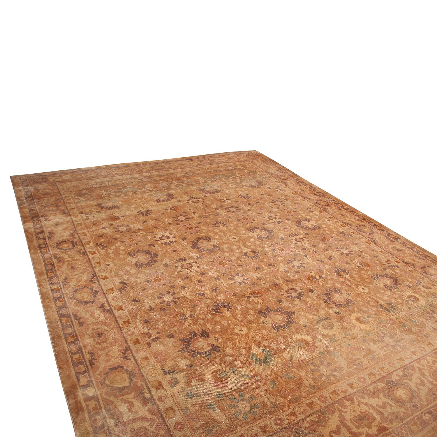 Hand knotted in Turkey originating between 1890-1900, this antique Oushak wool rug enjoys an inviting, meticulous symmetry in its floral pattern complementing variety of rich green, peach, and brown-black accents highlighting its finesse and