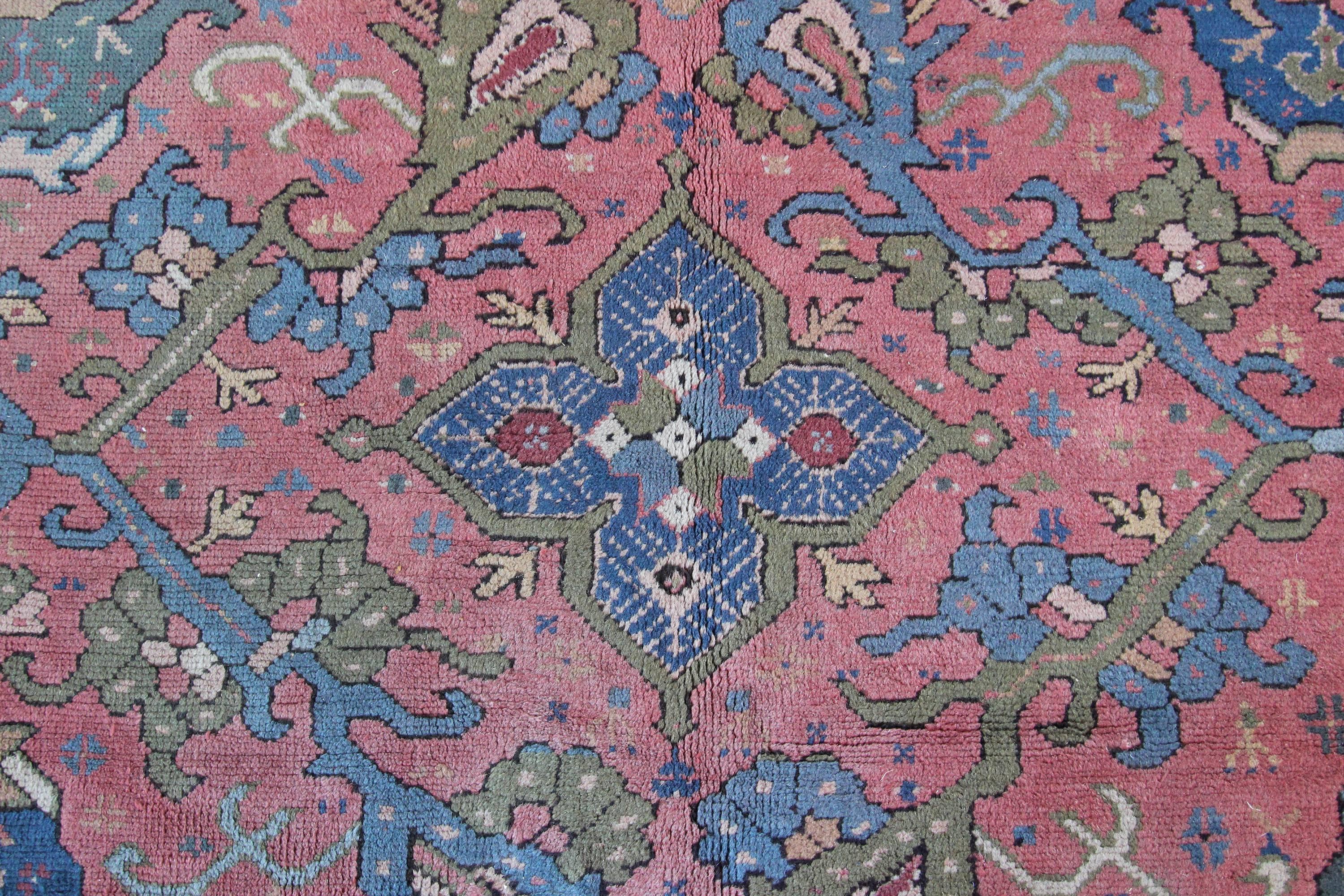 A very decorative antique Oushak carpet from Western Anatolia which was one of the largest rug production areas since the Ottoman Empire. Beautiful soft colours on this piece, soft pinks, greens and pale blues. Often younger Ushaks or Oushak rugs