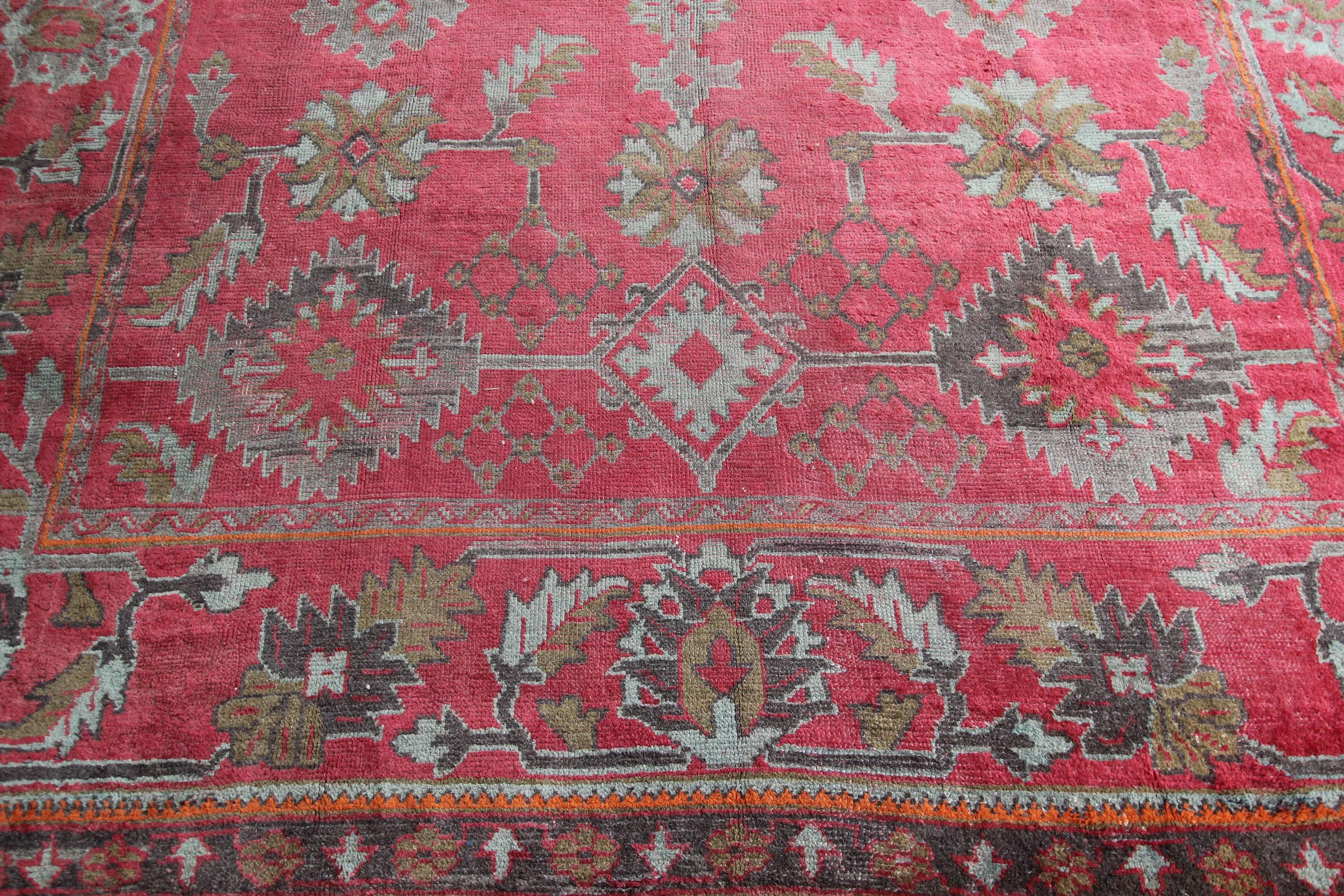 An unusual square antique Ushak carpet from Western Anatolia with glorious soft red and green colors. One of the largest rug production areas since the Ottoman Empire, Ushak designs tend to be more open than Persian rugs and softer dyes are not