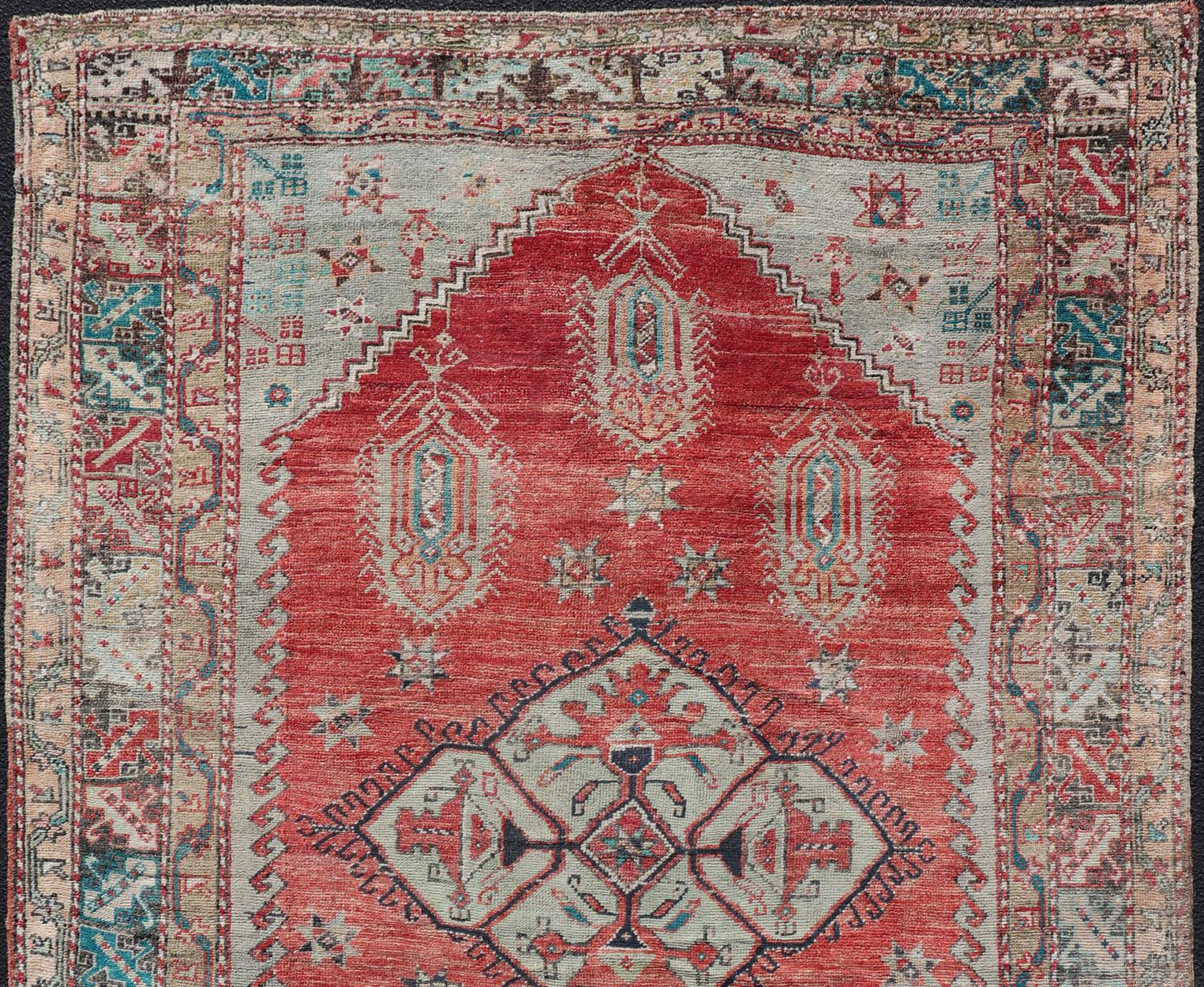 Vibrant Medallion design Turkish antique rug, rug EN-179973, country of origin / type: Turkey / Oushak, circa 1920

This antique Turkish oushak rug features a large medallion. The entirety of the piece is surrounded by a multi-tiered border of