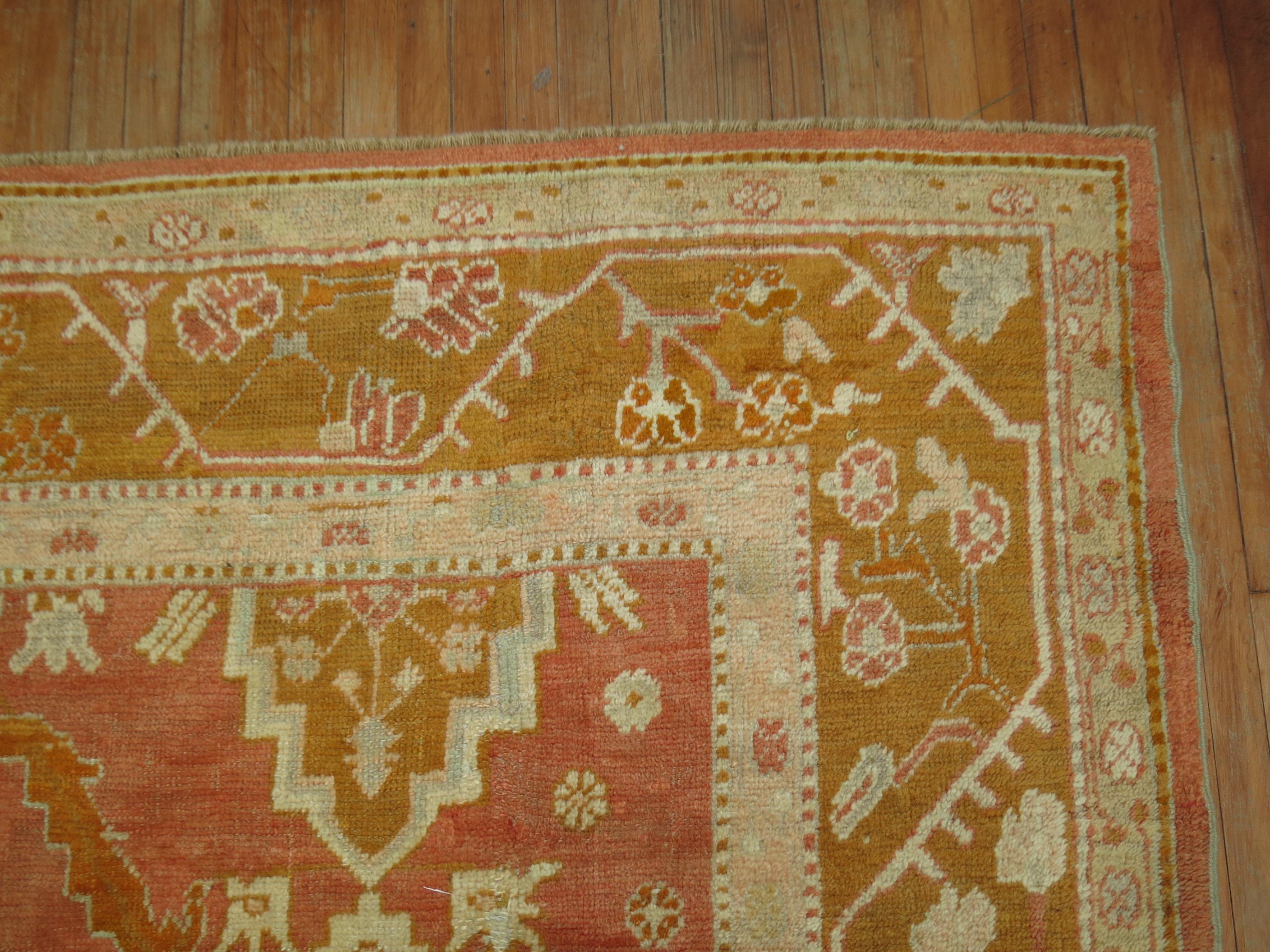 A late 19th century-early 20th century antique Turkish Oushak rug in predominant bright orange accents.