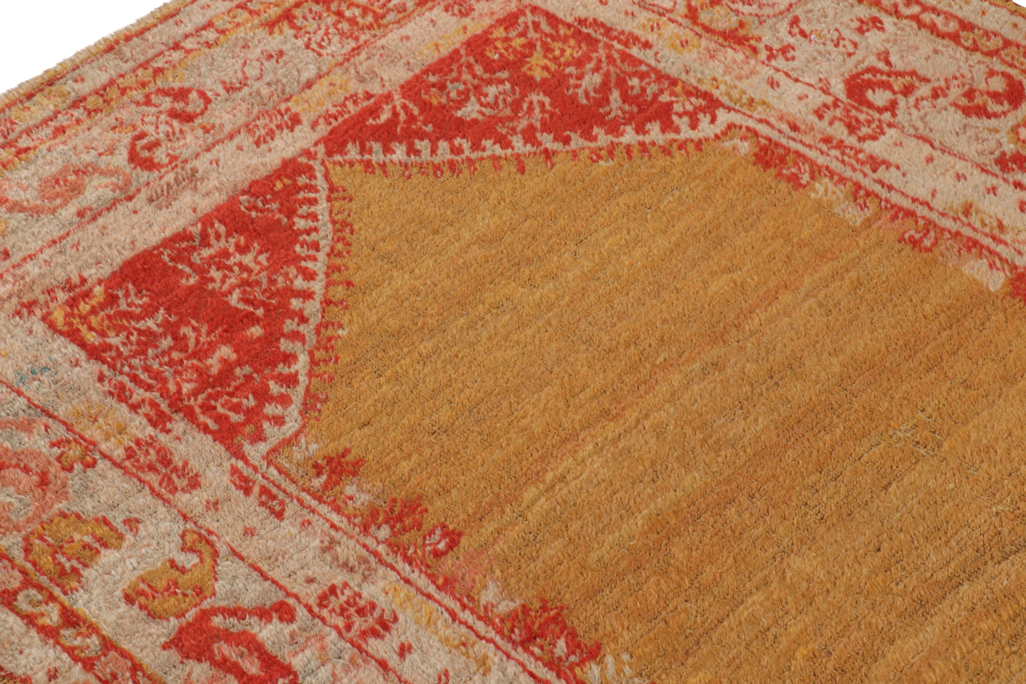 Originating from Turkey in 1890, this antique Oushak rug is hand knotted with particularly plush, sleak angora wool, lending it a silk-like sheen complemented by the ornate combination of vermillion red and sunset gold colourways; further accented