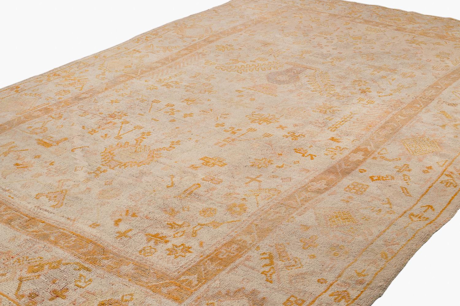 This antique Ouskak is an exceptional piece. This type of Oushak is very desirable based on the design and colors. The beautiful colors are very ethereal and subtle. For its age, this rug is in very good condition with very silky wool that is