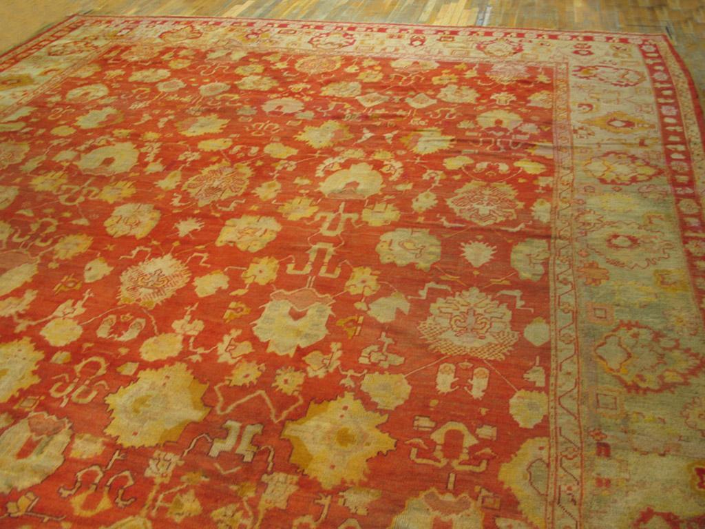 A red field with an orange tinge is the foil for an in and out palmette and coloudband pattern loosely adapted from classical 17th century Indo-Isfahan carpets. The pale green matching border has the same historical roots. The wide proportions are