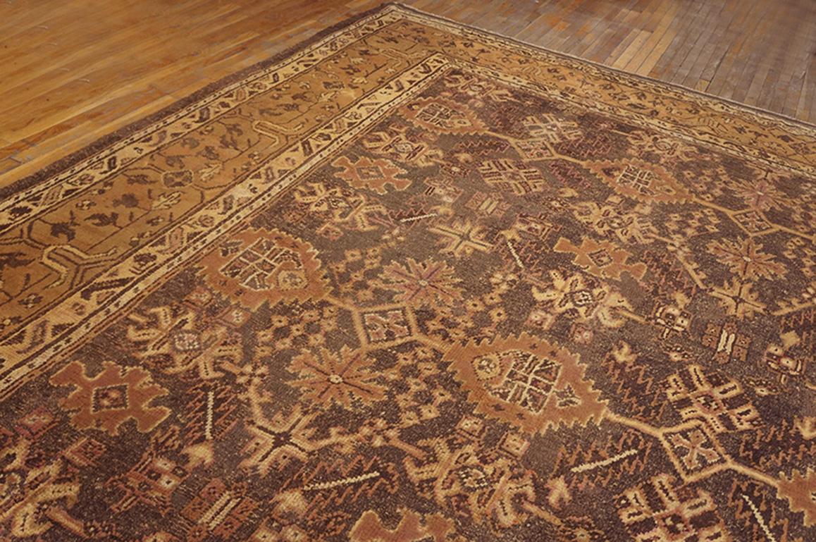 A two-tone palette emphasizing medium brown with a light green border is uncommon with older Oushak rugs. The all-over pattern of horizontal bars with saw-tooth lozenges, symmetrised palmettes, diagonal leaves and oblique dot arrays has no specific