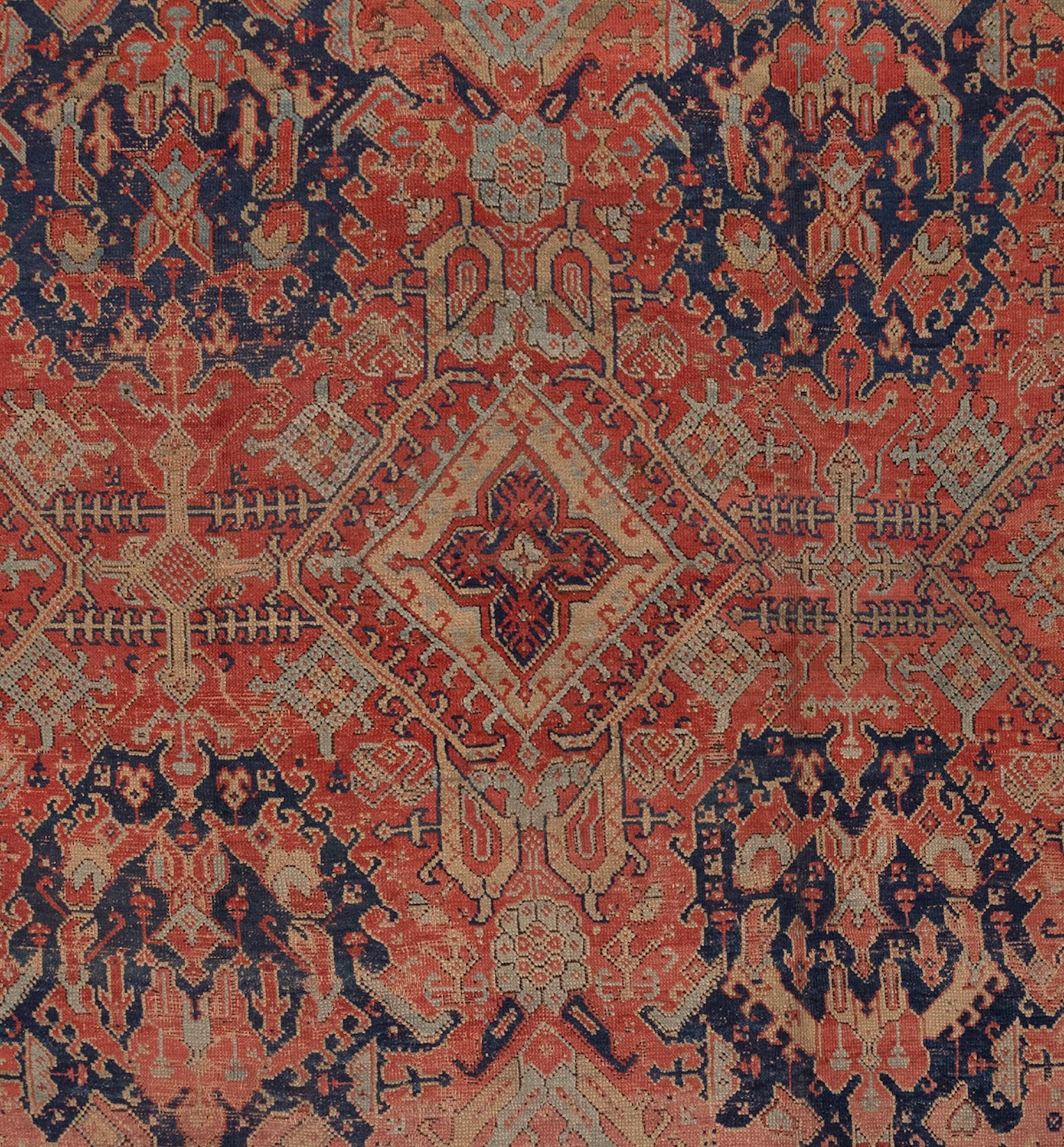 Large square Oushak rug with lovely red, navy, cream and light celedon green. This Oushak rug has a short, soft pile and is an unusual square size.