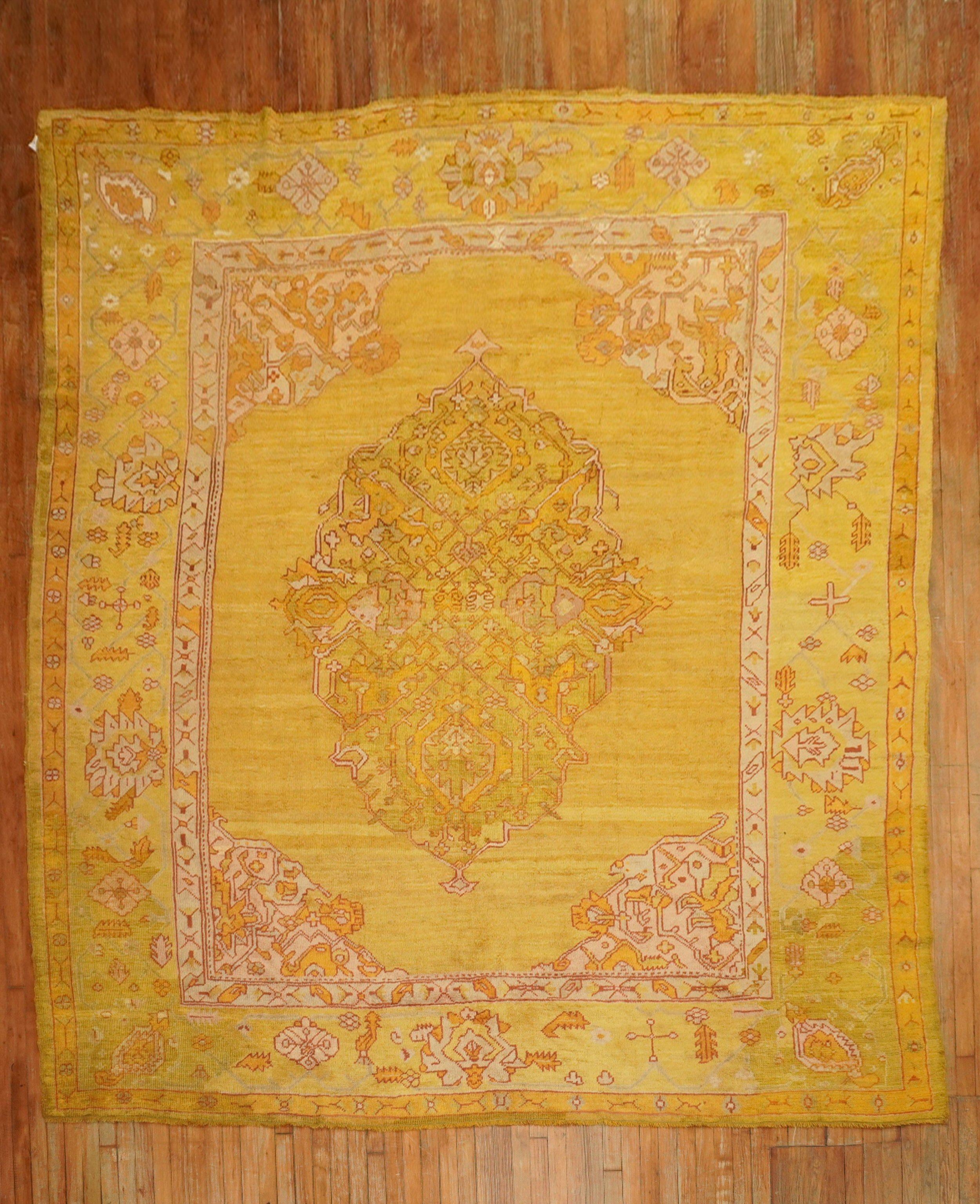 Sublime early 20th-century Turkish Oushak rug with a medallion and border on a gold field, accents in yellow, green, orange, and red

Measures: 9'5