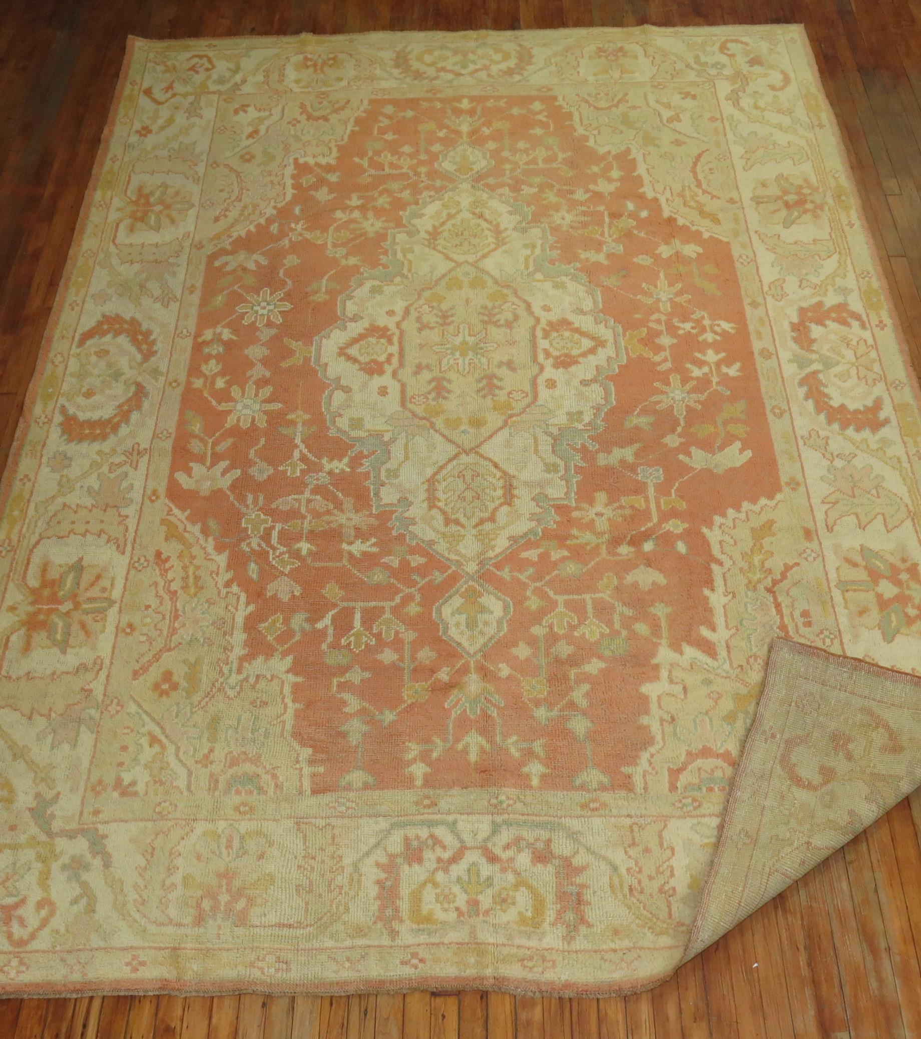 An early 20th-century room size orange field antique Oushak 

Measures: 8'9” x 11'10”.