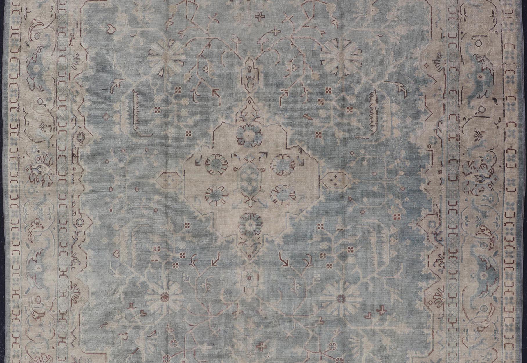 Antique Turkish Oushak Rug with Medallion With Light Gray-Blue, Cream, and Brown. Keivan Woven Arts / rug EN-142046, country of origin / type: Turkey / Oushak, circa Early-20th century. 

Measures: 10'9 x 14'2.

Classical designs and muted colors