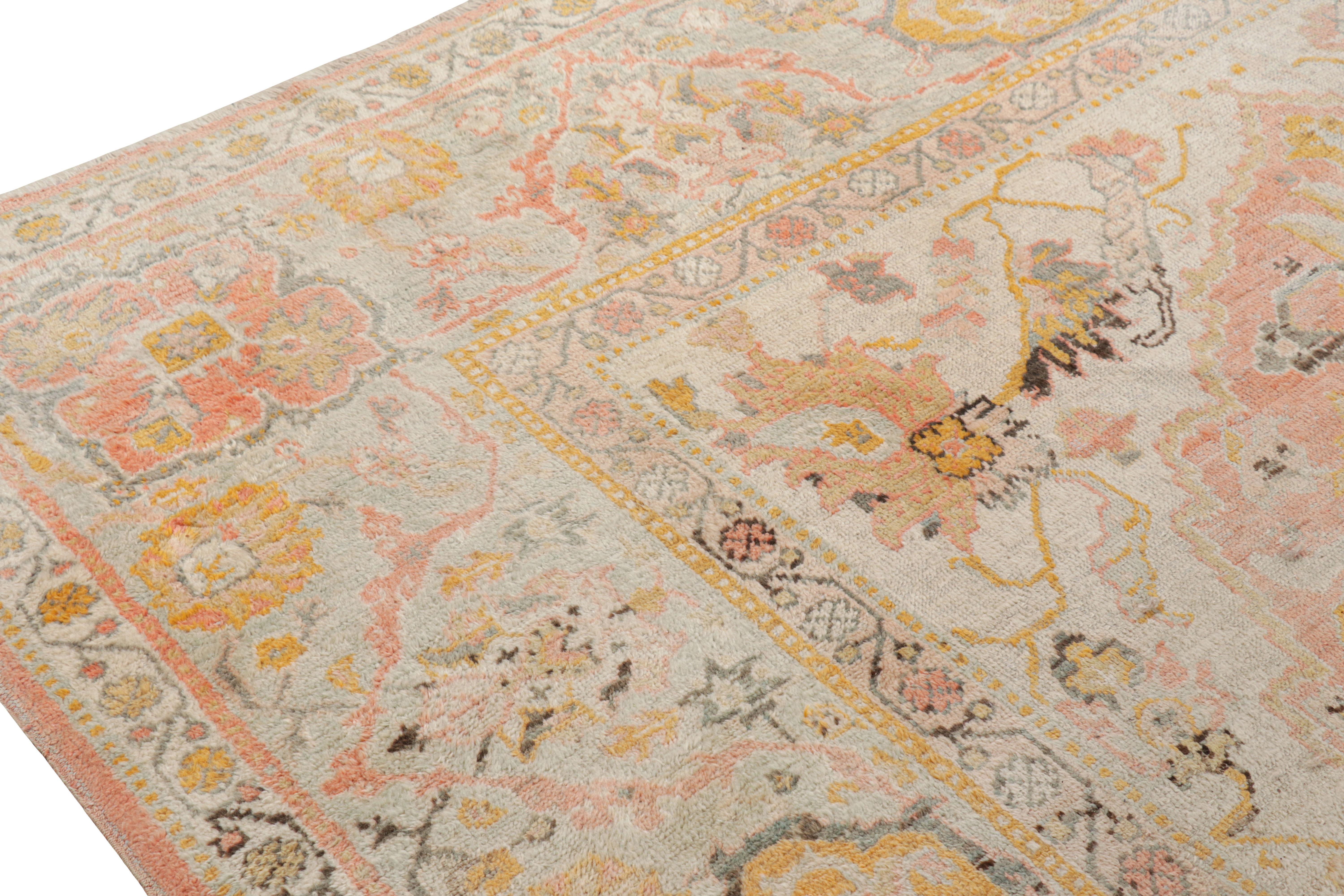 Wool Antique Oushak Rug in Pink with Blue and Gold Floral Patterns For Sale