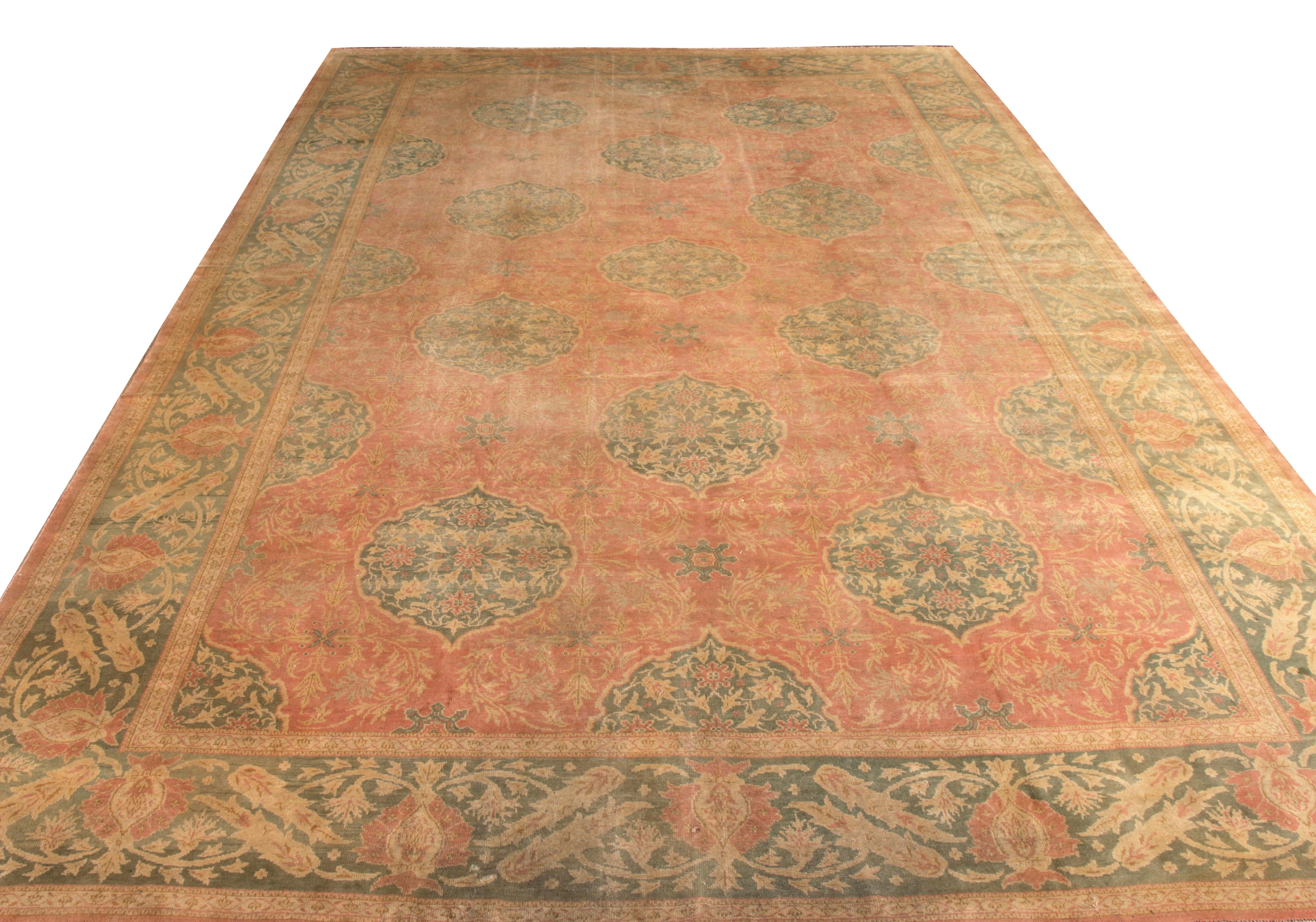 Hand knotted in wool from Turkey circa 1920-1930, an antique 12x17 Oushak rug revelling in classic sensibilities of the era. The collectible marries a delicate floral pattern with luscious red and green colors in an iconic, seldom-seen pattern to
