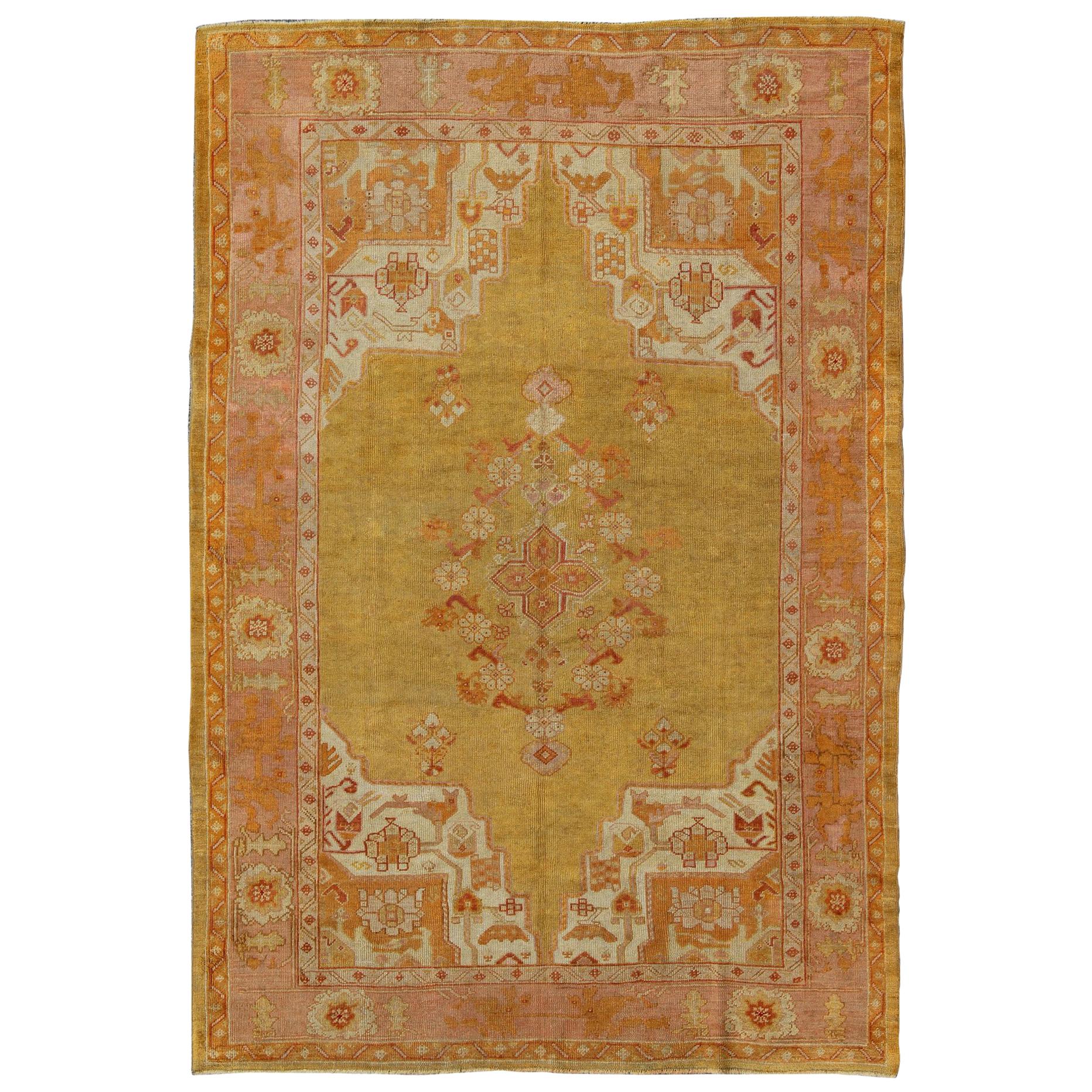 Antique Oushak Rug in Yellow Green Background, Pink Border, Red & Orange Accents For Sale