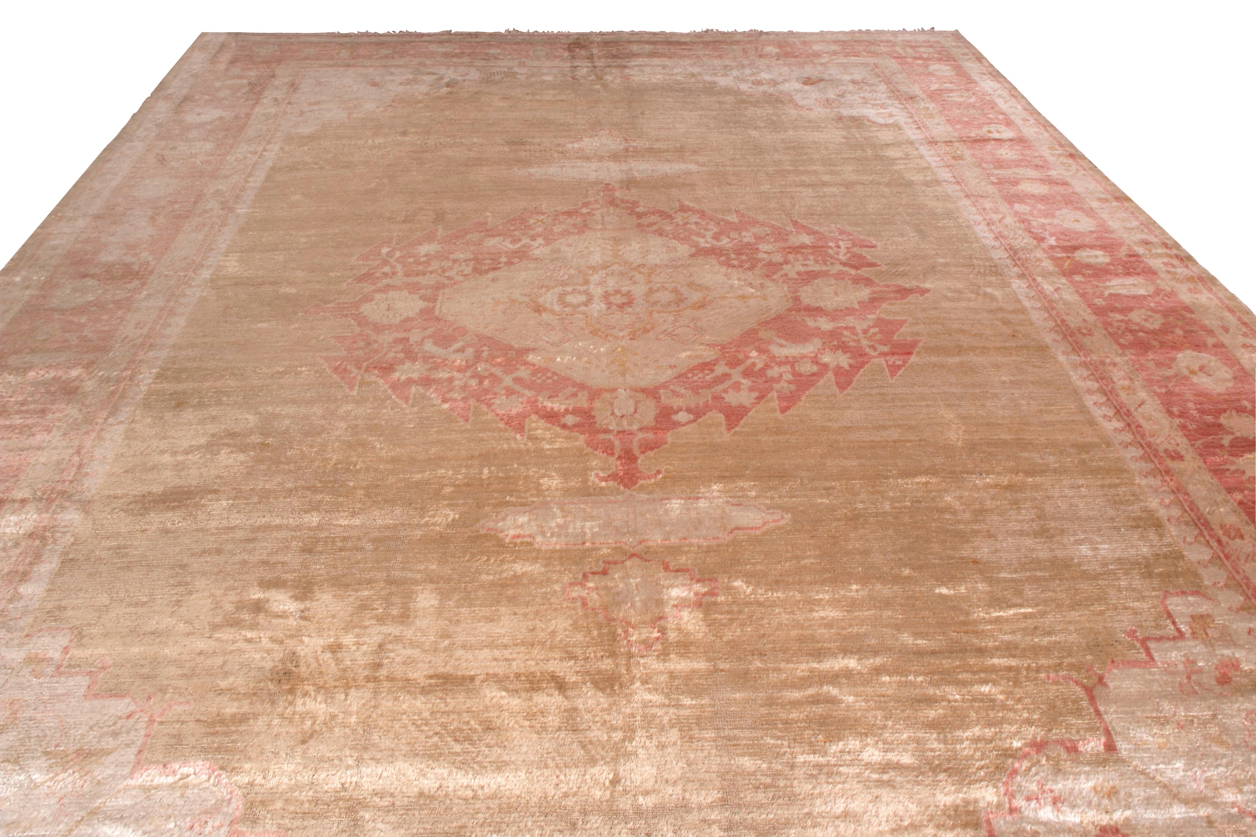 Hand knotted in notoriously sheen angora wool originating from Turkey between 1900-1910, this antique rug connotes an early 20th century medallion-style Oushak design in a rich traditional pallet of burnt red and beige-gold tones. The natural luster