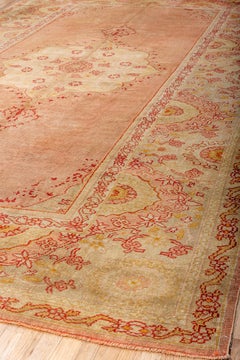 Antique Oushak Rug with Red Pink Tones