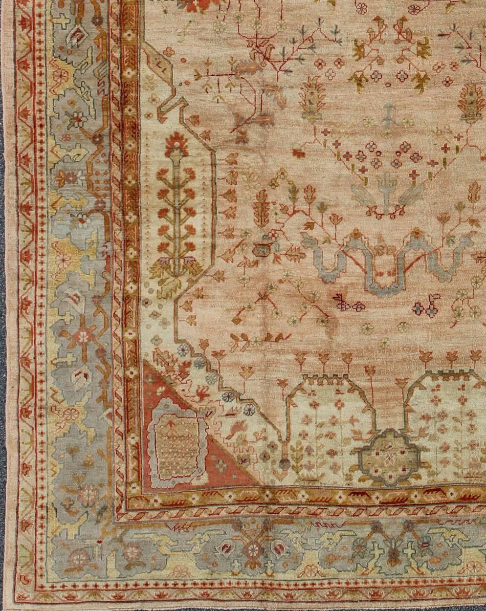 Unique Turkish Oushak rug with Sub-geometric and floral design in pink, blue, light gray, tan, light green, taupe, red, yellow and yellow green. rug S12-1213, country of origin / type: Turkey / Oushak, circa 1900

Measures: 11'3 x 16'8

The design