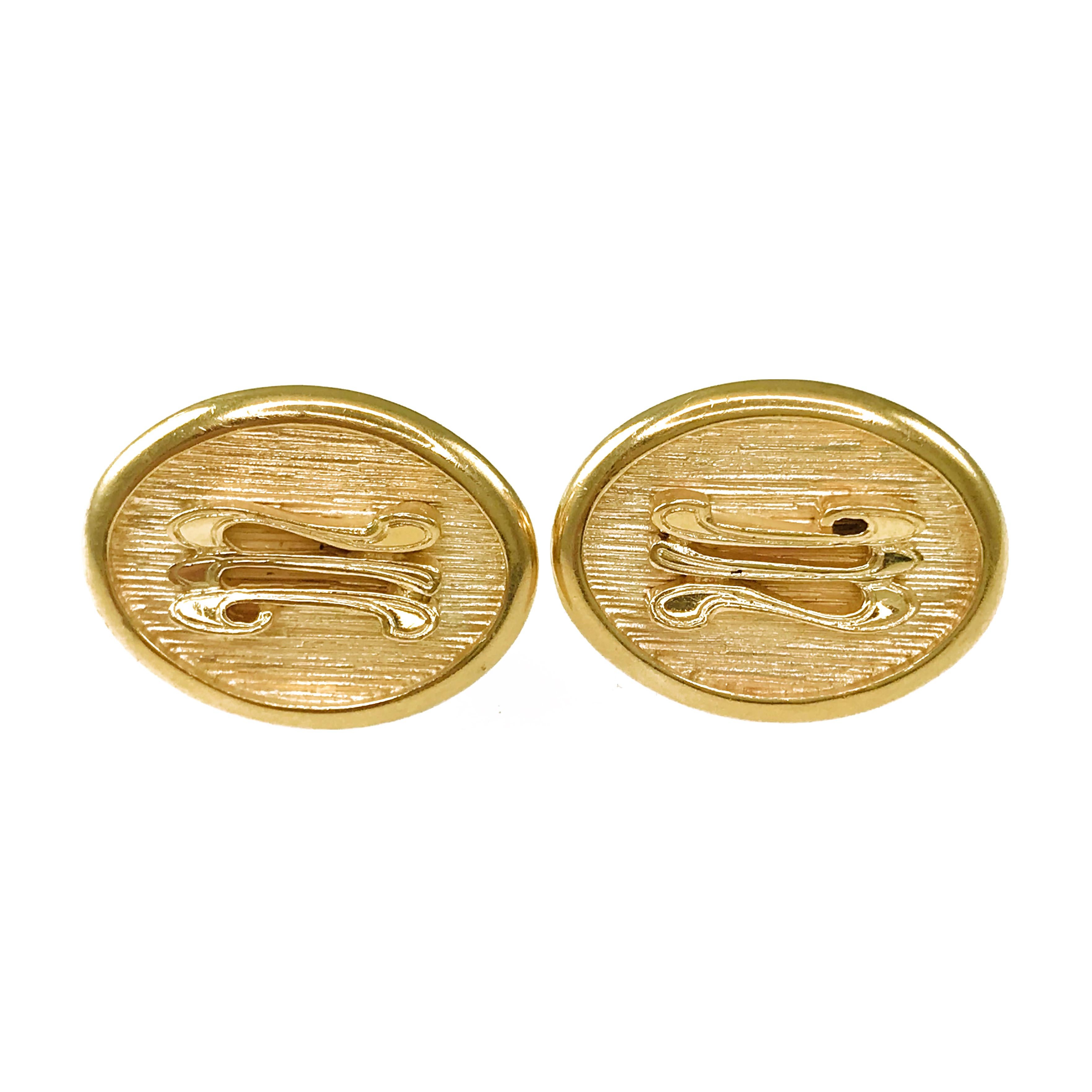 Antique Oval 14 Karat Gold Cufflinks. These cufflinks have a bezel edge and highly textured center finish with a letter M in relief. The cufflinks have a dual post and bullet backing. Engraved on the back of one cufflink is 6-5-59 and on the other