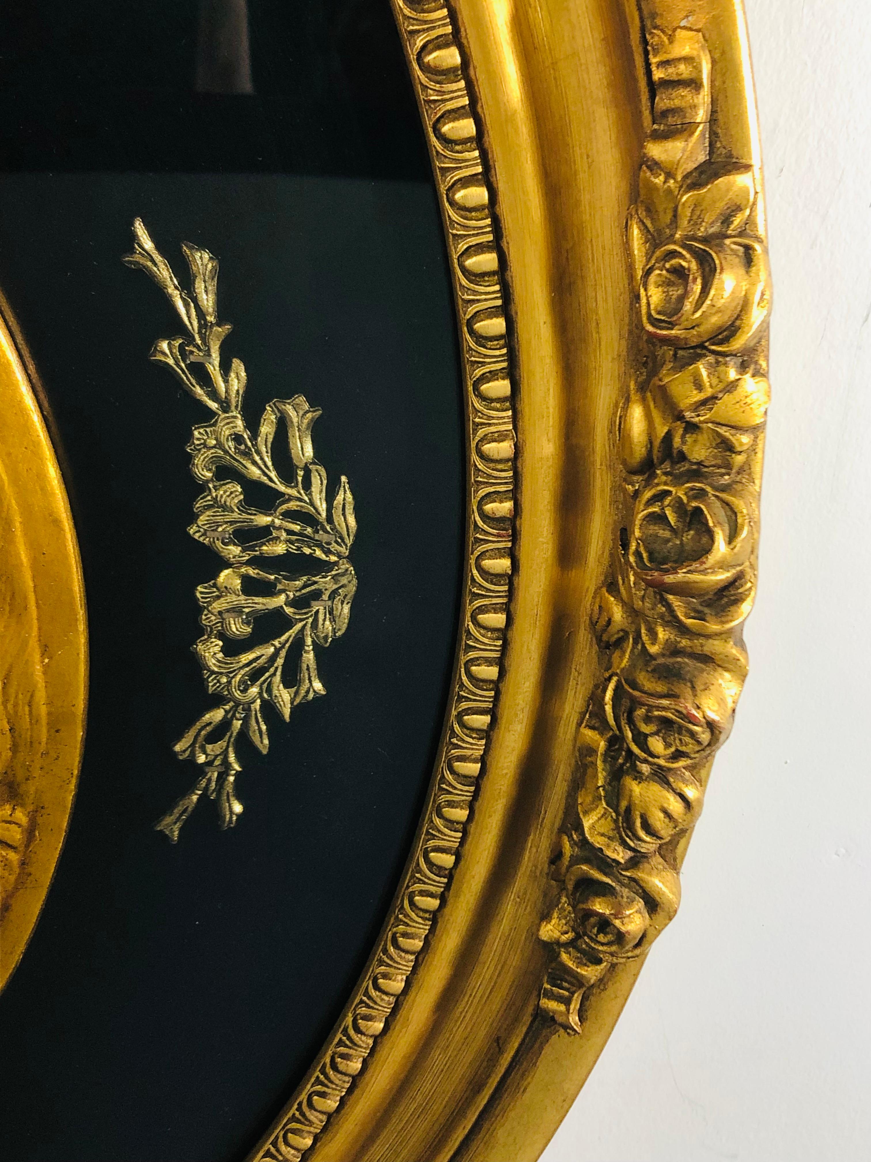 20th Century Antique Oval Black and Gold Winged Cherubs Wall Art Plaque  For Sale