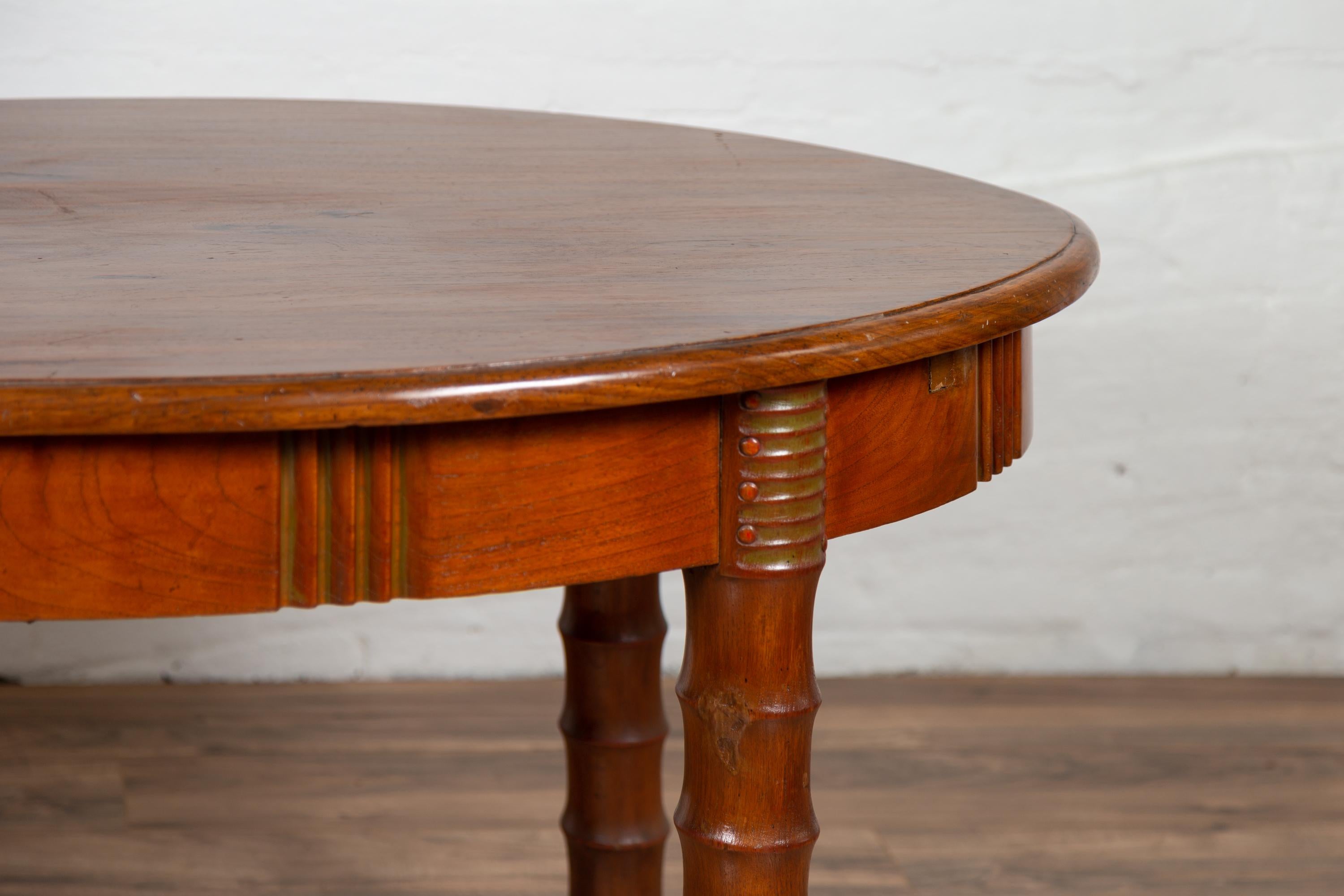 20th Century Antique Oval Dining Room Table from Indonesia with Spindle Legs and Warm Patina For Sale