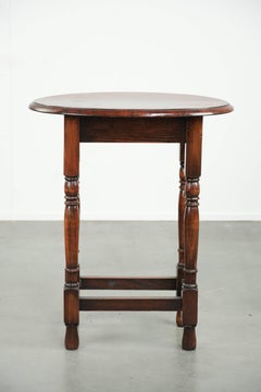 Antique oval English oak side table from the early 20th century