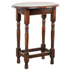 Antique oval English oak side table from the early 20th century