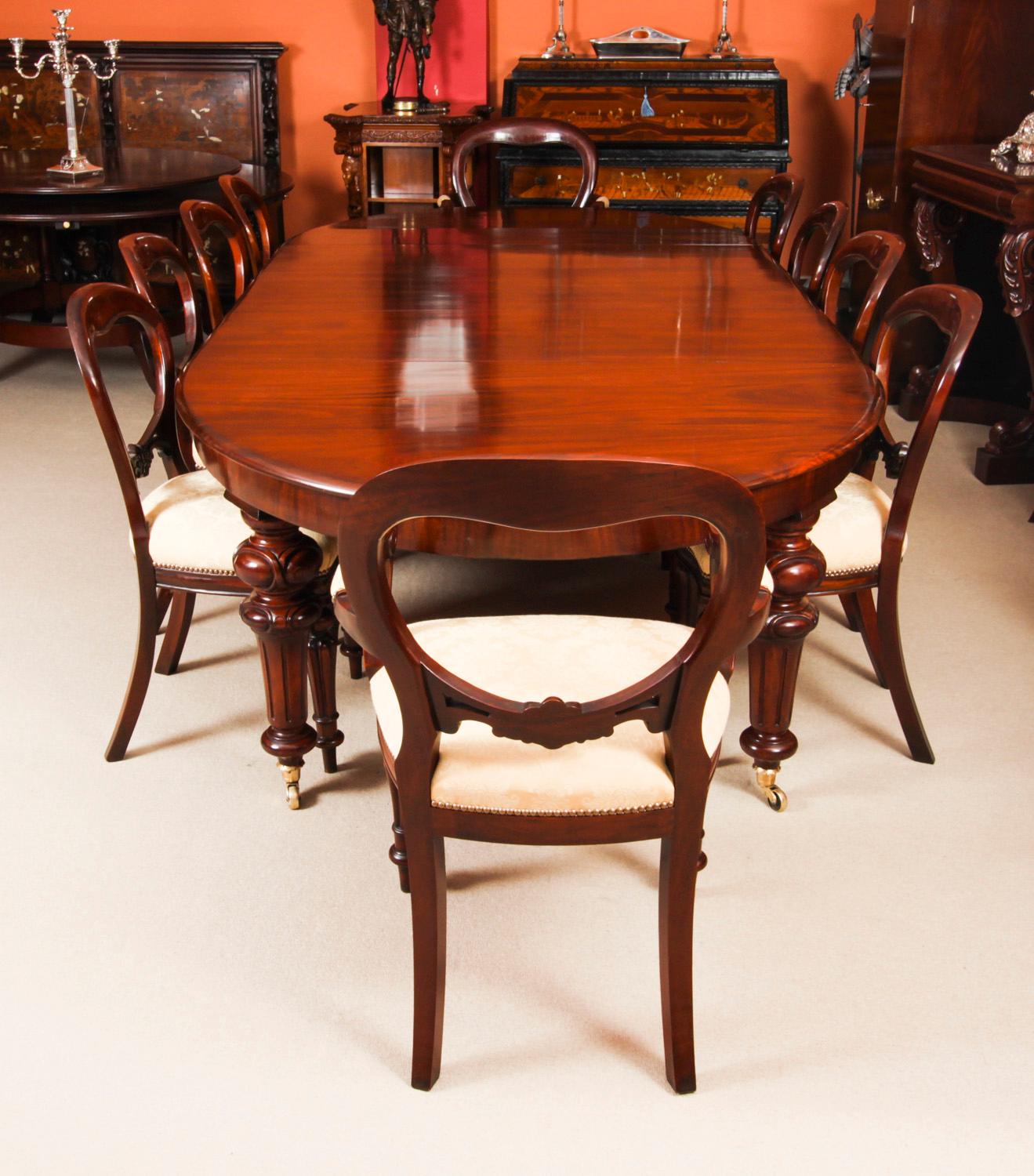 This is a fabulous antique early Victorian oval flame mahogany extending dining table, circa 1850 in date, with a vintage set of ten balloon back dining chairs.

The table has two original leaves, can comfortably seat ten, and it has been