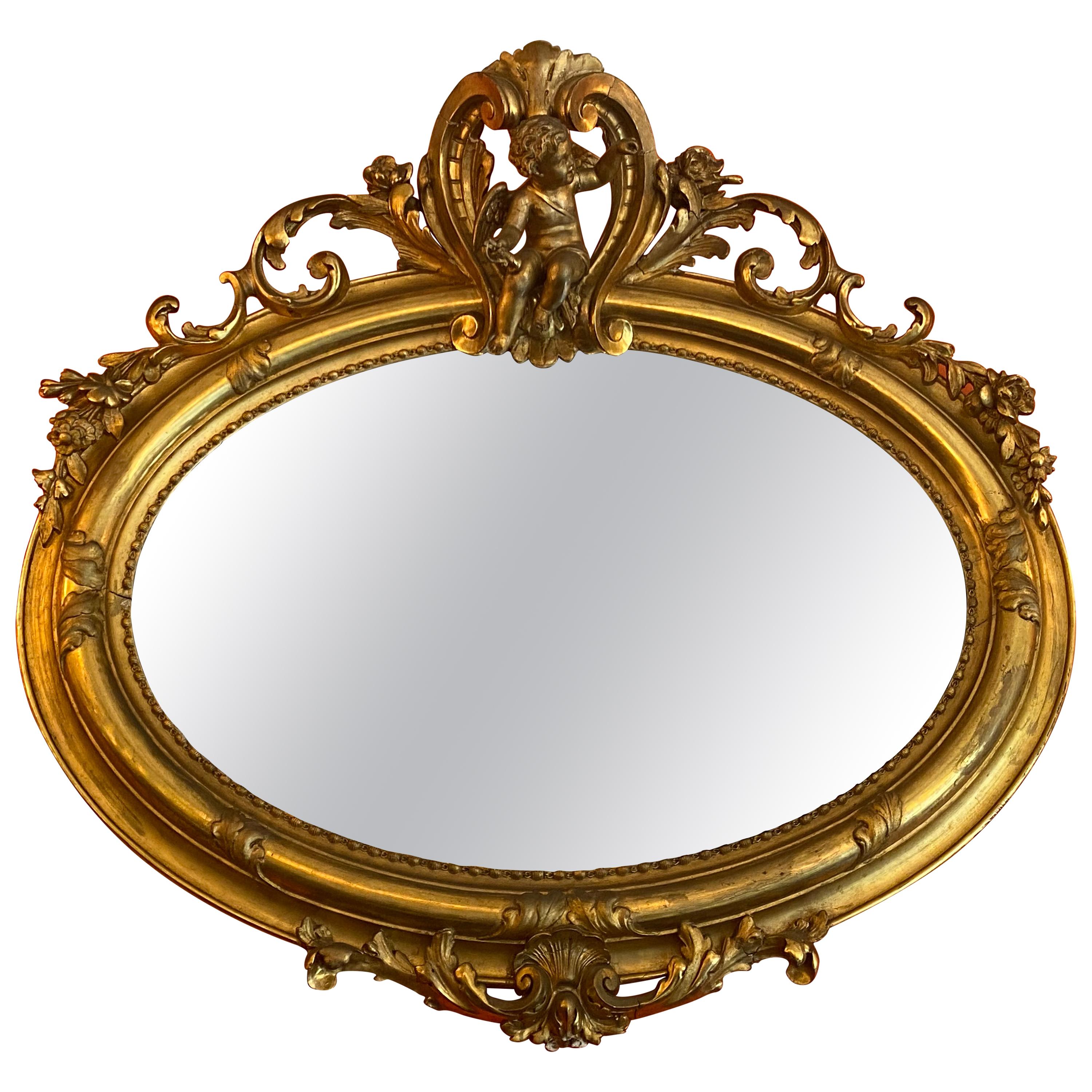 Miroir ovale ancien en or doré en vente