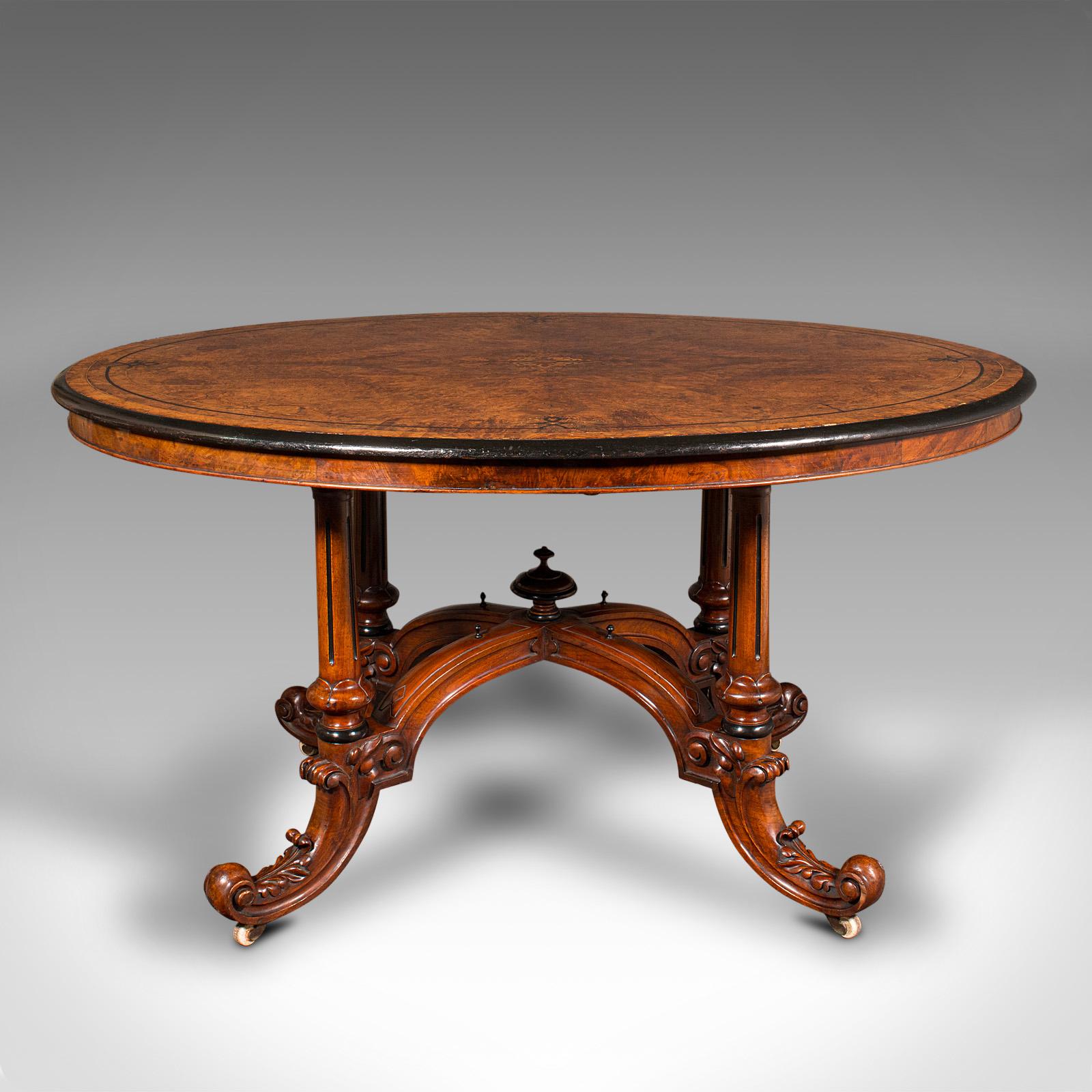 This is an antique oval Looe table. An English, burr walnut and boxwood inlaid 4-seat centrepiece table, dating to the early Victorian period, circa 1840.

Exceptional craftsmanship and figuring - a table of fine distinction
Displaying a desirable