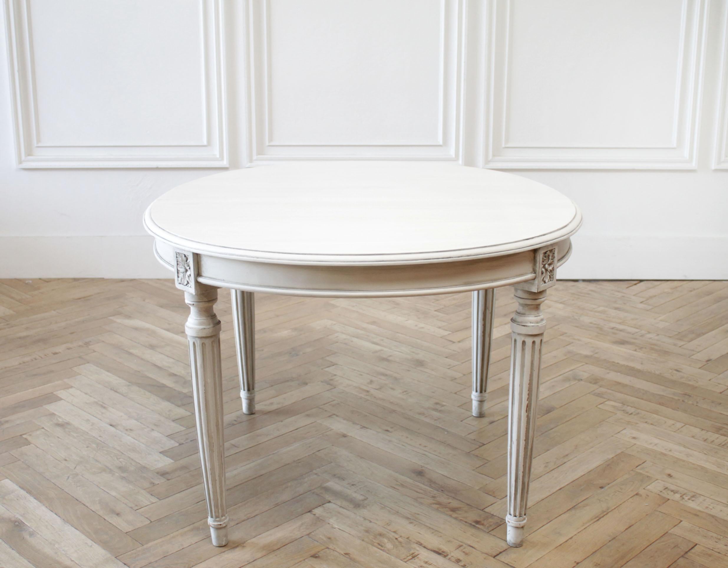 Antique oval Louis XVI style painted dining table
Painted in an oyster color, which is off-white, with subtle distressed edges, and finished with an antique glazed patina. It does lean towards a slight gray tone.
Solid walnut there is a seam in