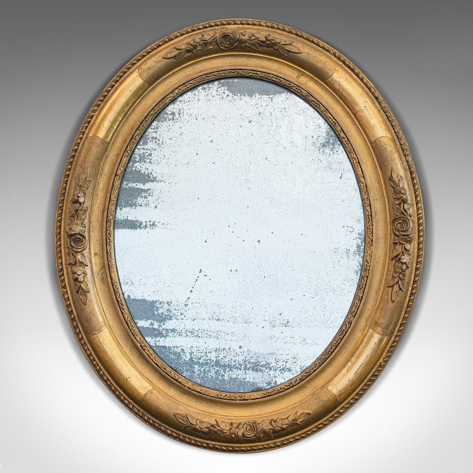 This is an antique oval mirror. An English, gilt gesso mirror with mercury plate, dating to the Georgian period, circa 1800.

Superb Georgian mirror
Displays a desirable aged patina
Rich hues to gilt gesso frame
Desirable foxing to mercury