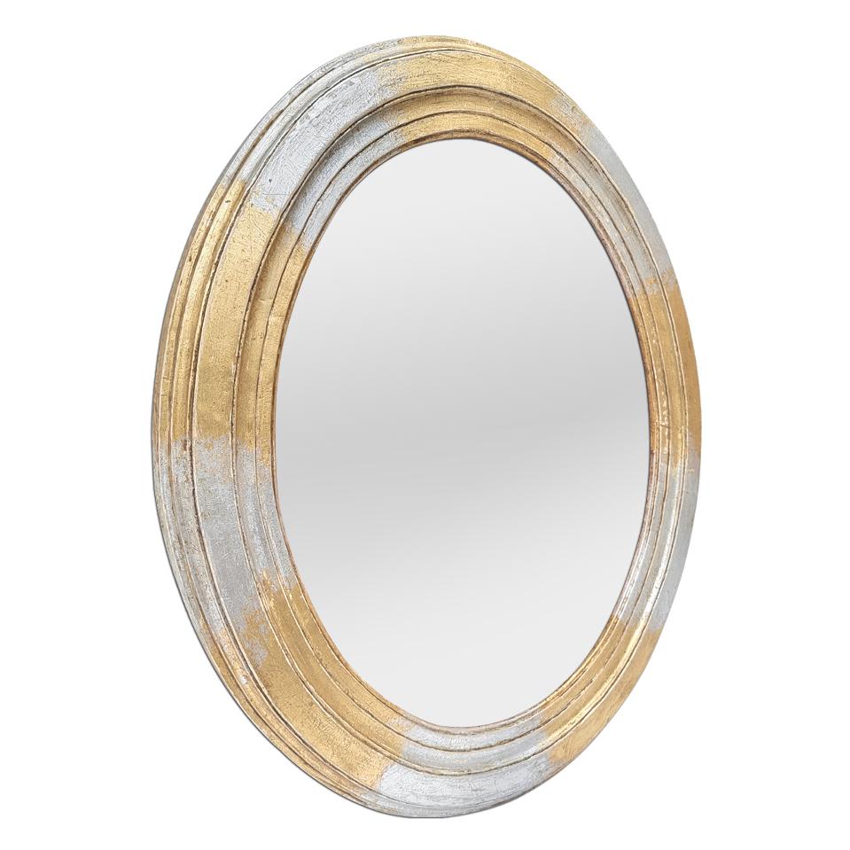 Antique French oval mirror, circa 1950. Wood oval frame, re-gilding to the patinated leaf, with alternating gilt and silvered. (Antique frame width measures: 6 cm / 2.36 in.). Modern glass mirror. Wood back.