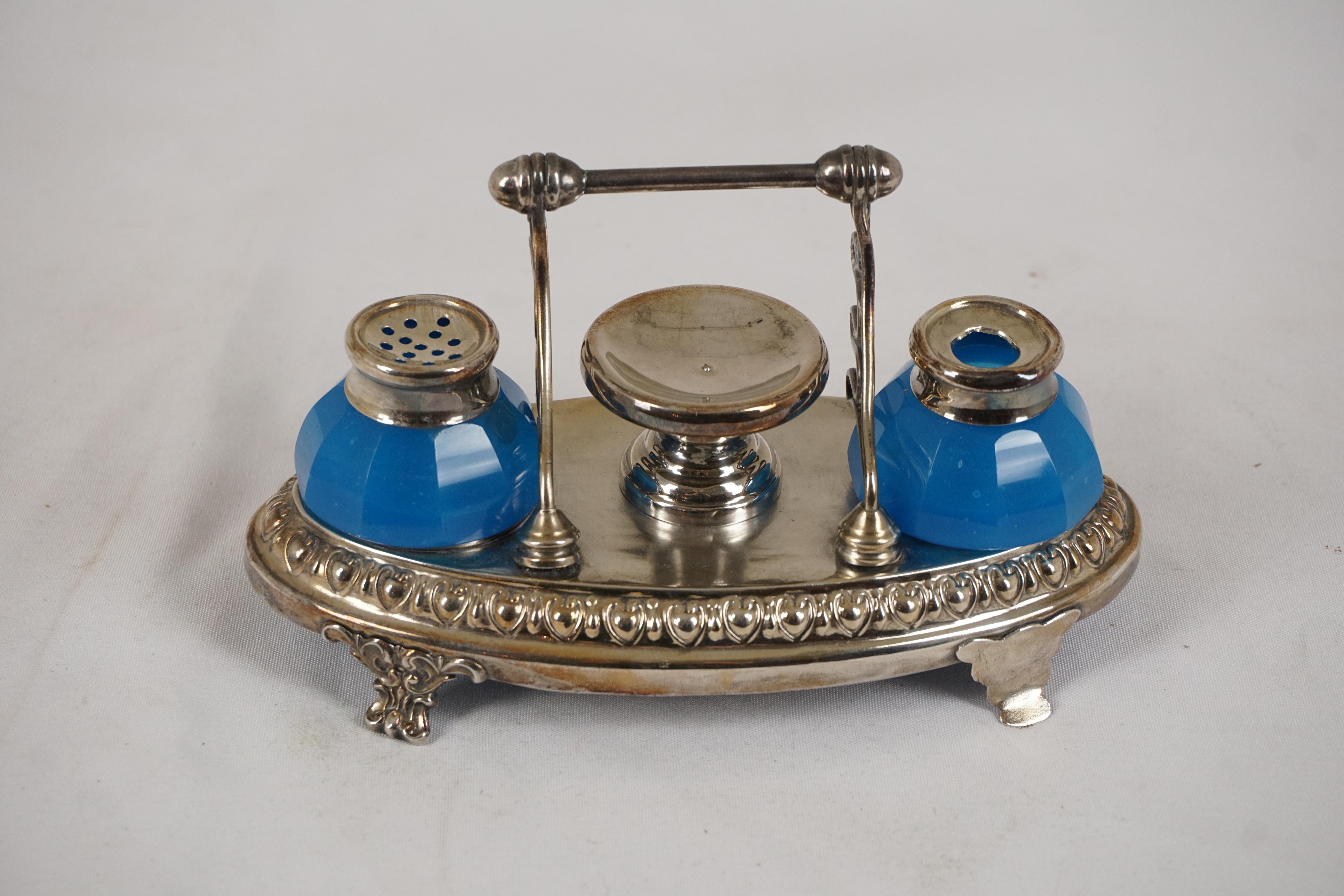 Antique Oval Silver Plated Double Inkstand, Scotland 1910, H549

Scotland 1910
Silver plate and glass
Silver plated inkstand having two blue glass inkwells
A handle with three pen rests to the back
With a stamp holder to the center
Please note one