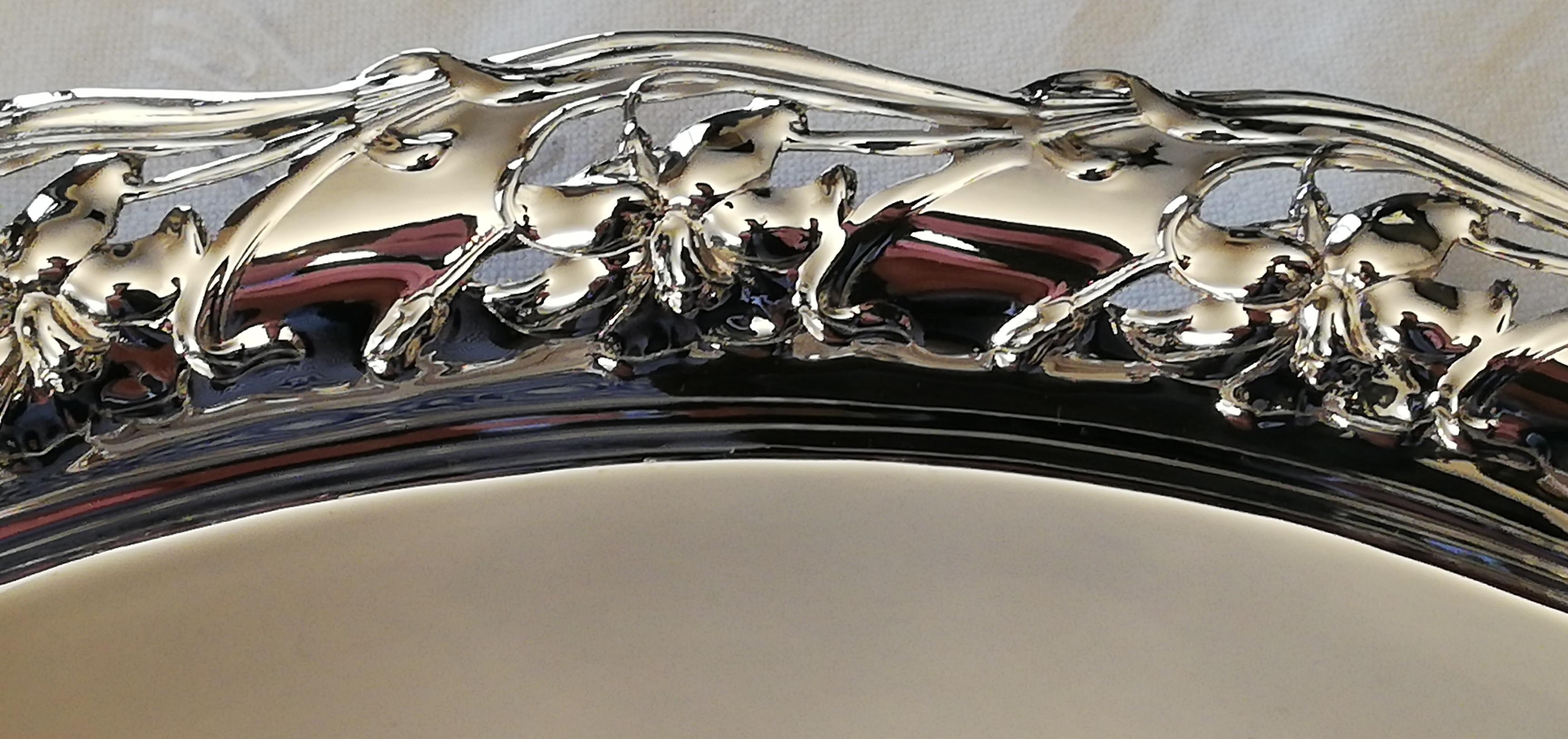 A hand forged silver tray, made in Germany. Produced in the first half of the 20th century. The oval-shaped tray has an open-worked, floral rim.