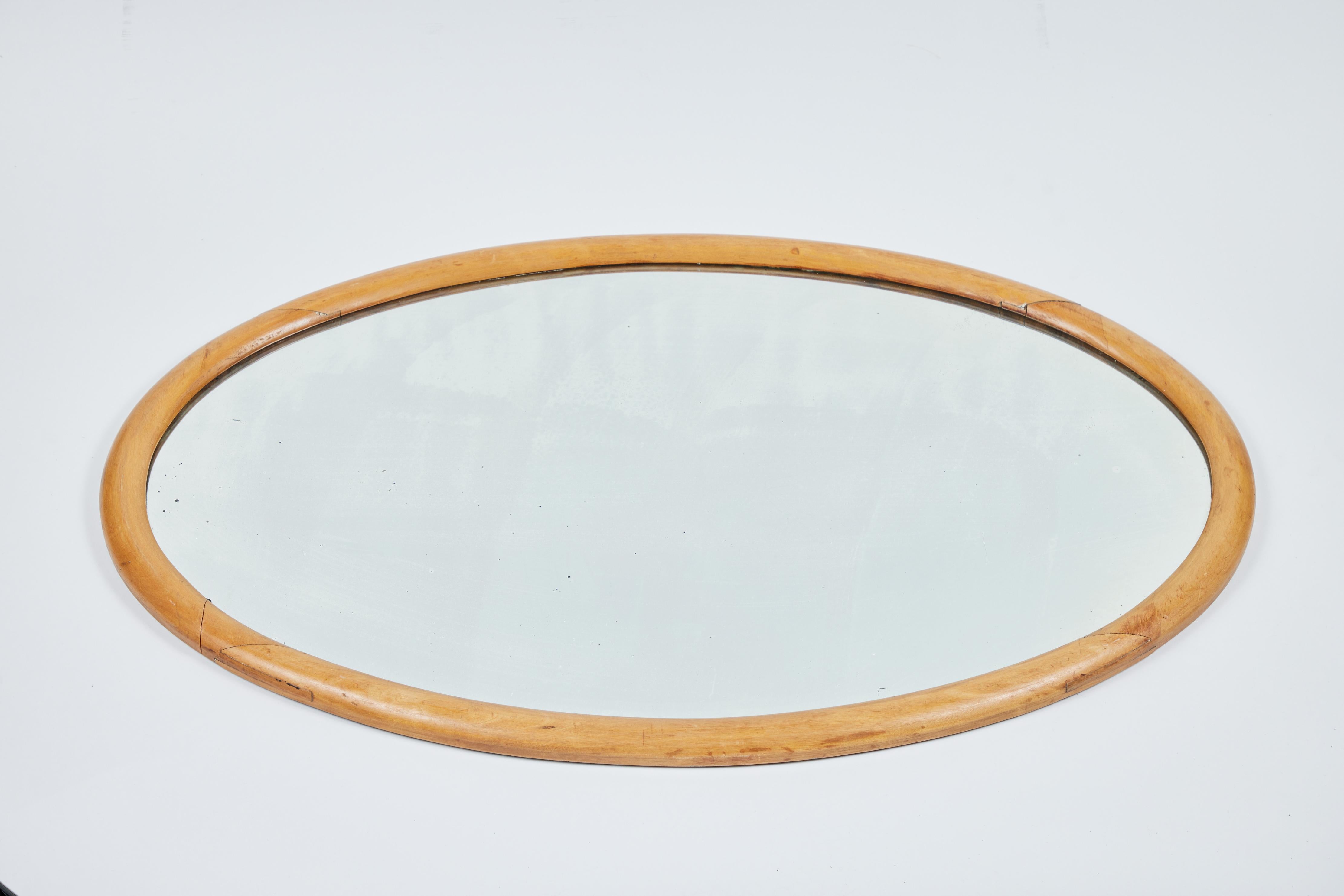 Antique oval wood frame mirror with original beveled glass.