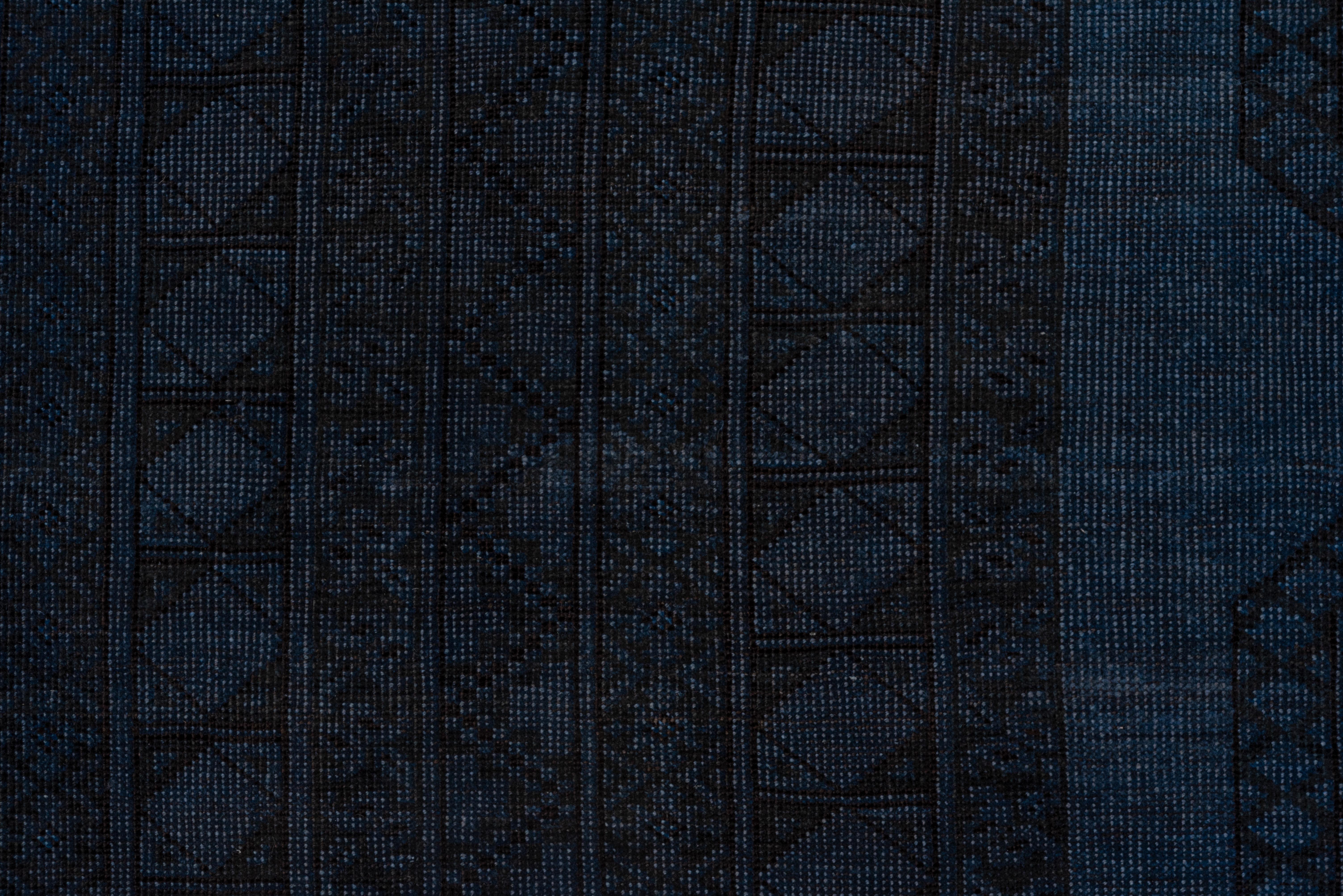 The underlying carpet is an Afghan-Ersari nomadic piece with a four by nine layout of tribal guls. It has been overdyed to give it a bluish overall tone.
