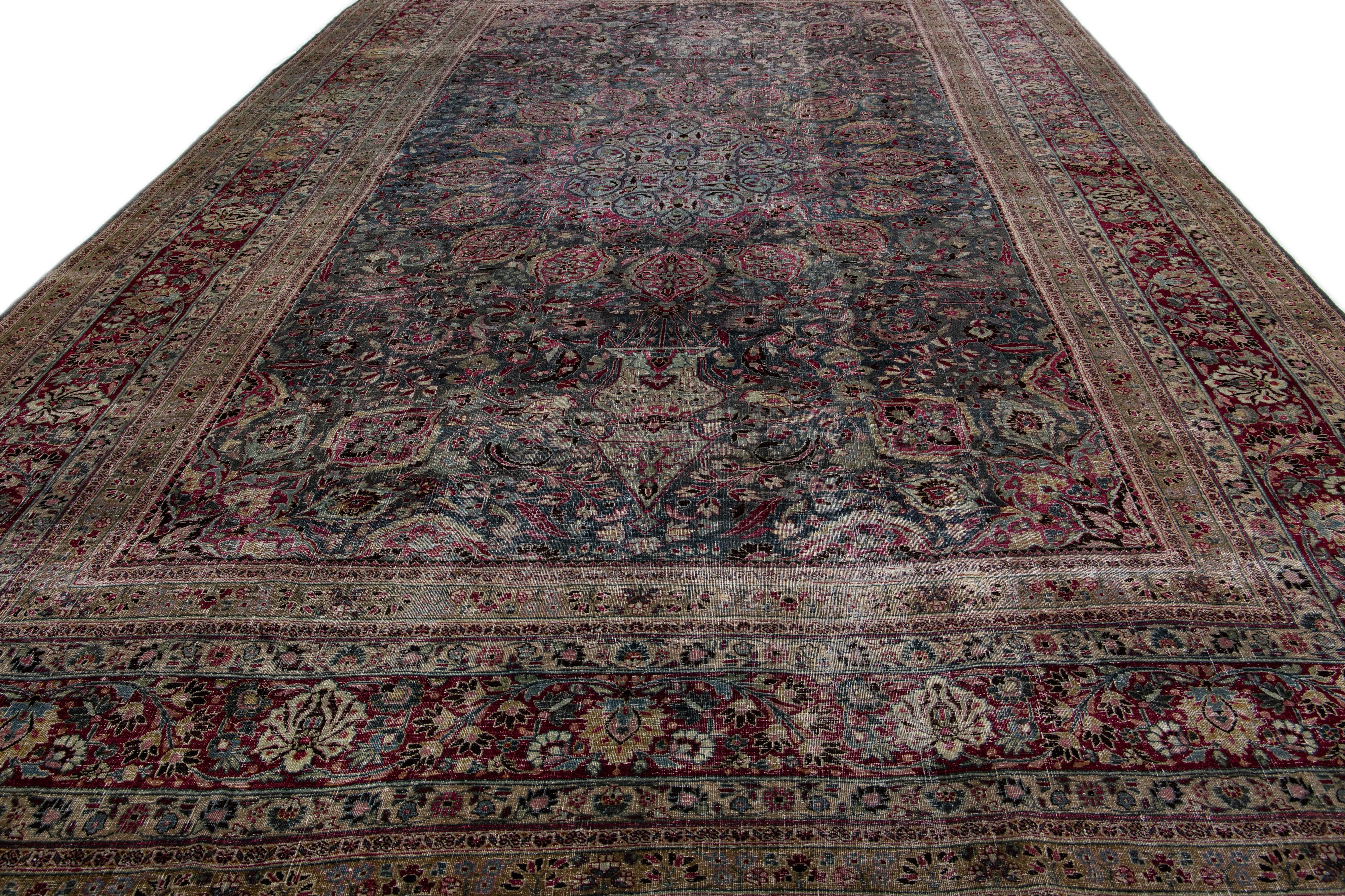 Beautiful antique overdyed hand-knotted oversize wool rug. This rug has a gray field with pink and tan accents in the center medallion design,

This rug measures: 11' 5