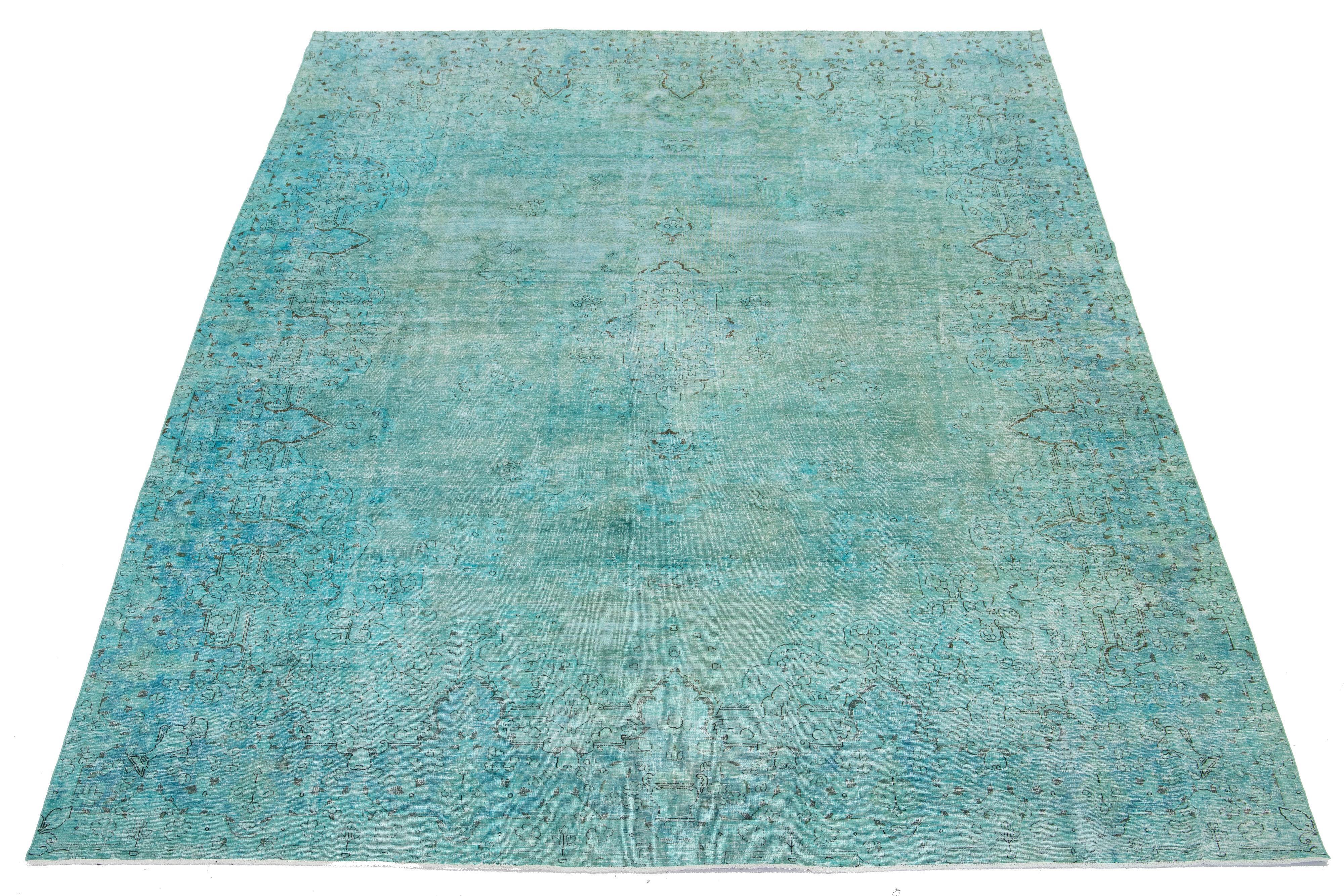 This is an antique hand-knotted wool Persian rug with a Turquoise field. It features a medallion floral design with gray accents.

This rug measures 8'9'' x 12'10