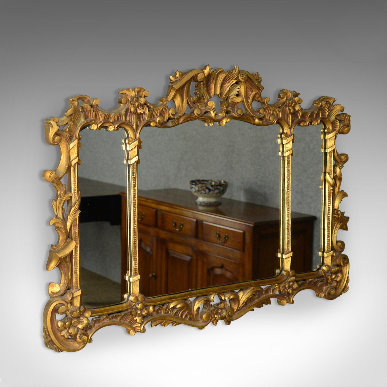 This is an antique overmantel mirror. An English, Regency revival, giltwood wall mirror divided as with a triptych and dating to circa 1900.

Attractive mellow golden tones in the giltwood frame
A quality piece in the Regency taste
Mid-sized and