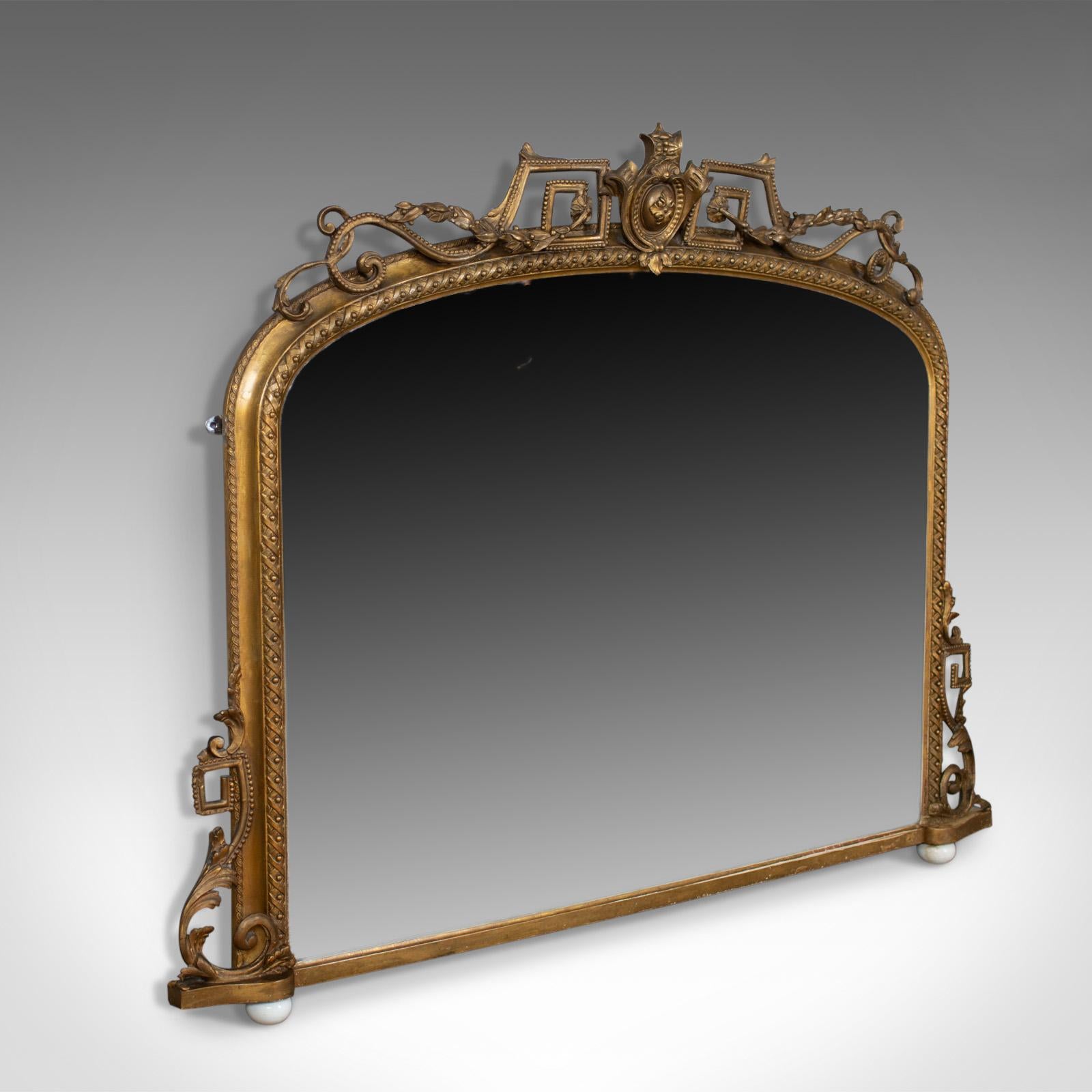 This is an antique overmantel mirror, a mid-sized, English, Regency wall mirror in giltwood frame dating to circa 1820.

Attractive mellow golden tones in the giltwood frame
A refined piece displaying classical overtones
Dome form with old